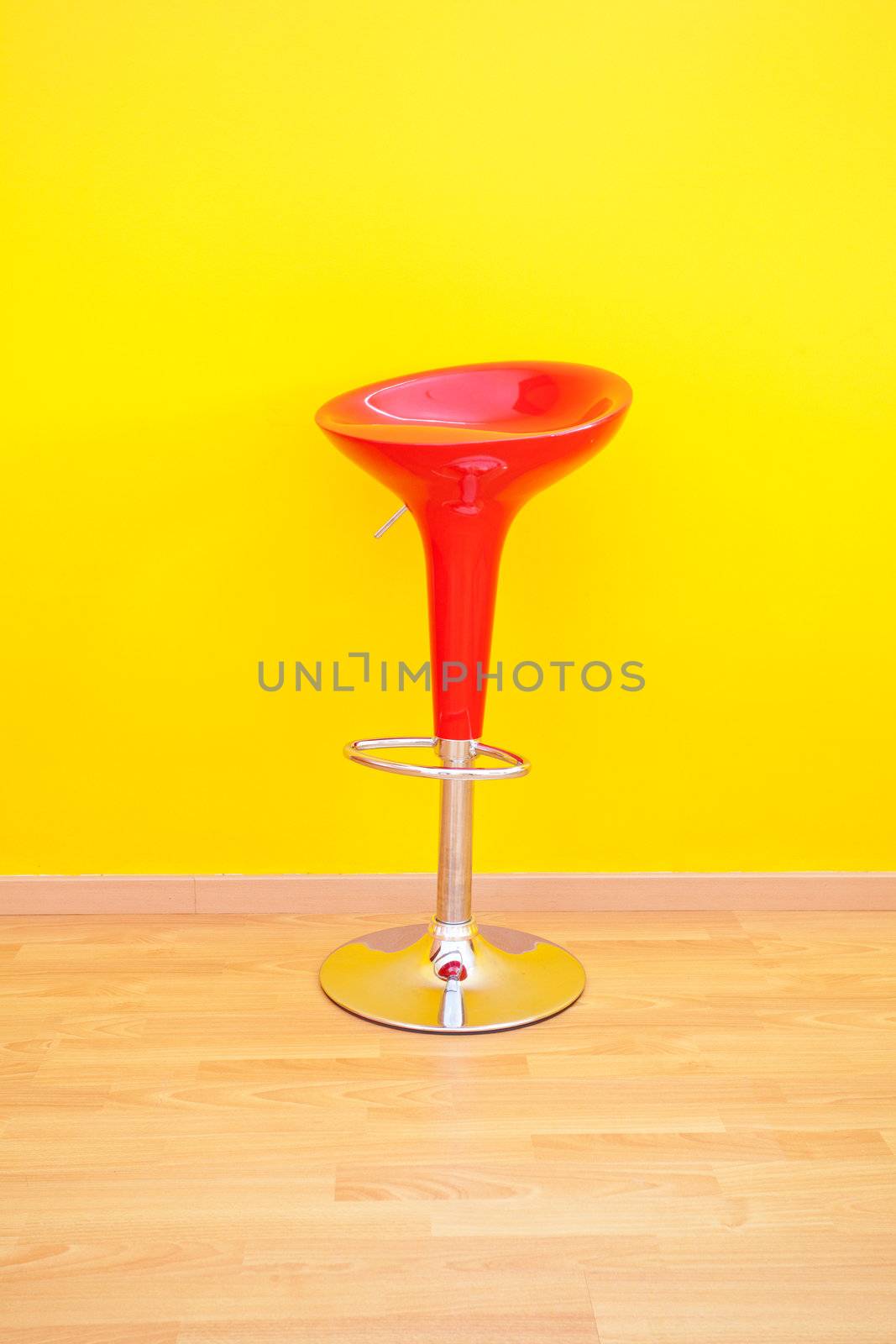 bar chair against a yellow wall in the apartment by jannyjus