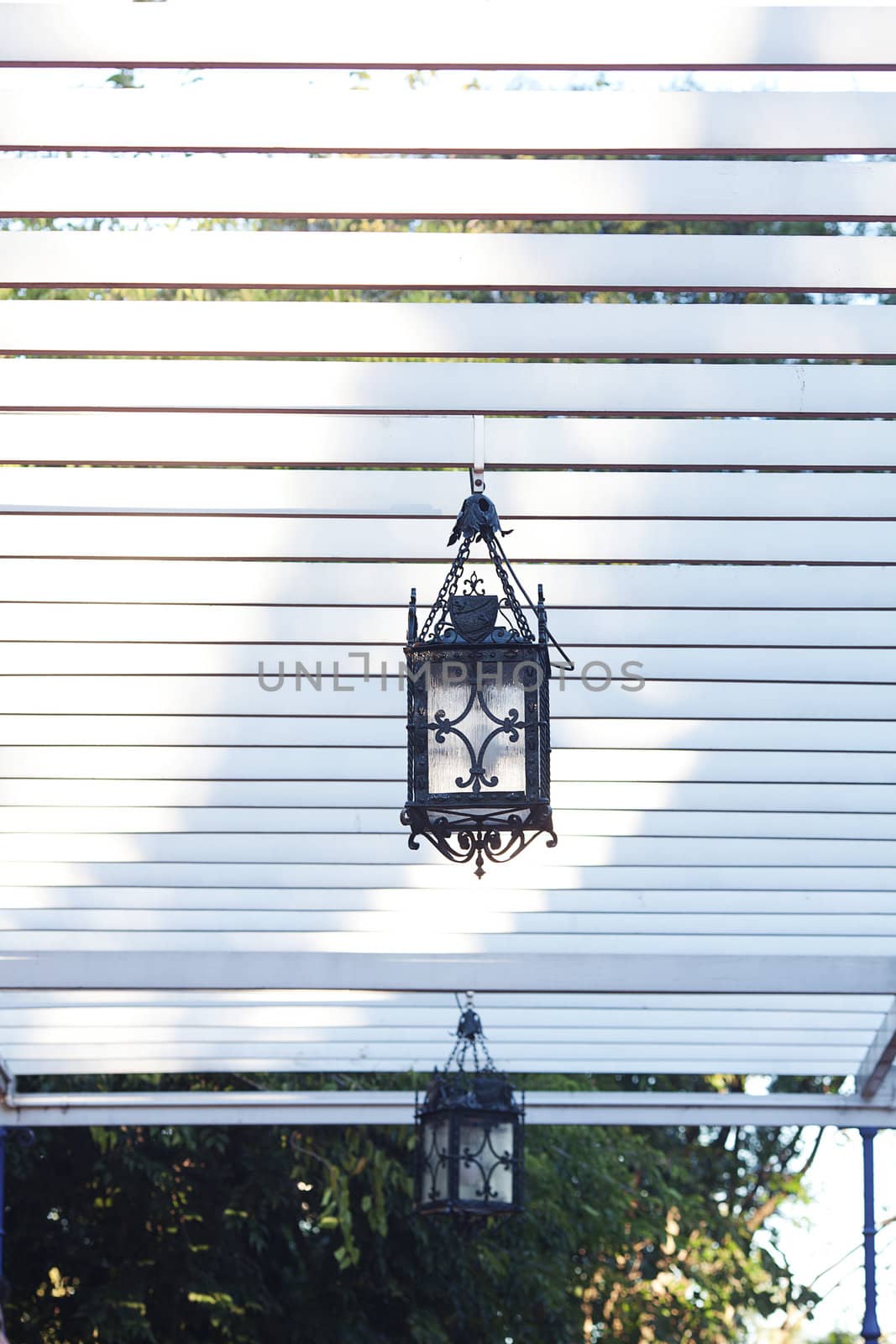 decorative lantern hanging in the arbor