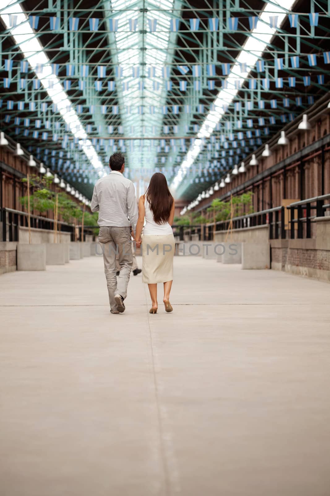 Couple Walking Holding Hands by leaf