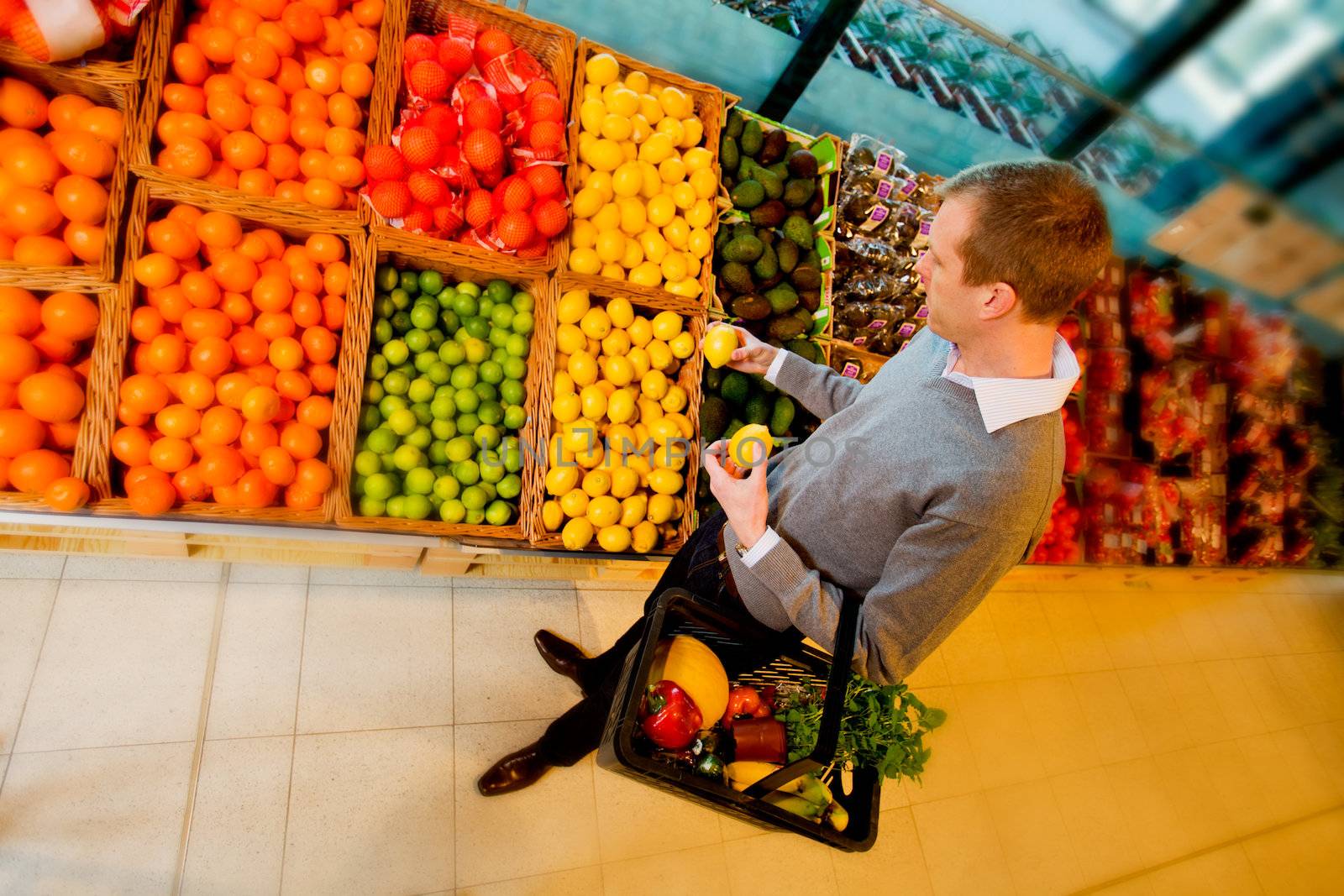 A man buying fruit in a grocery store