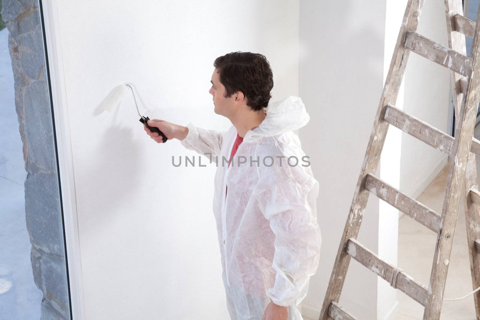 Painter painting the wall with roller