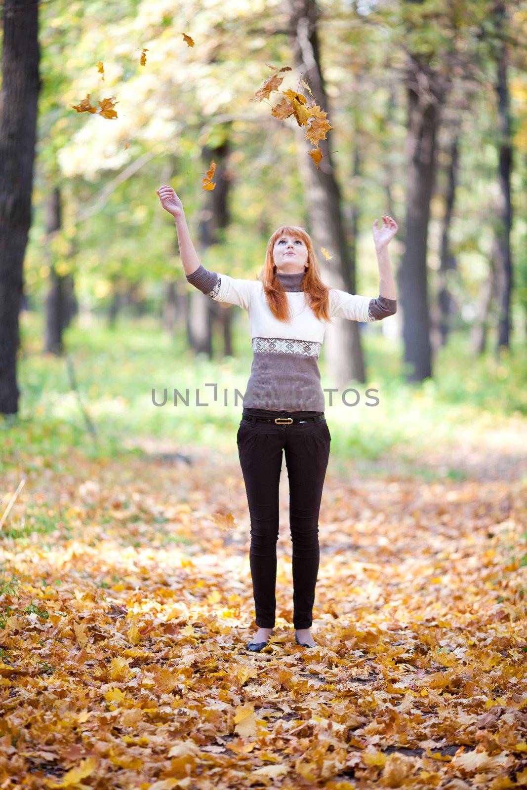 young redhead teenager throwing leaves woman in the forest   by jannyjus