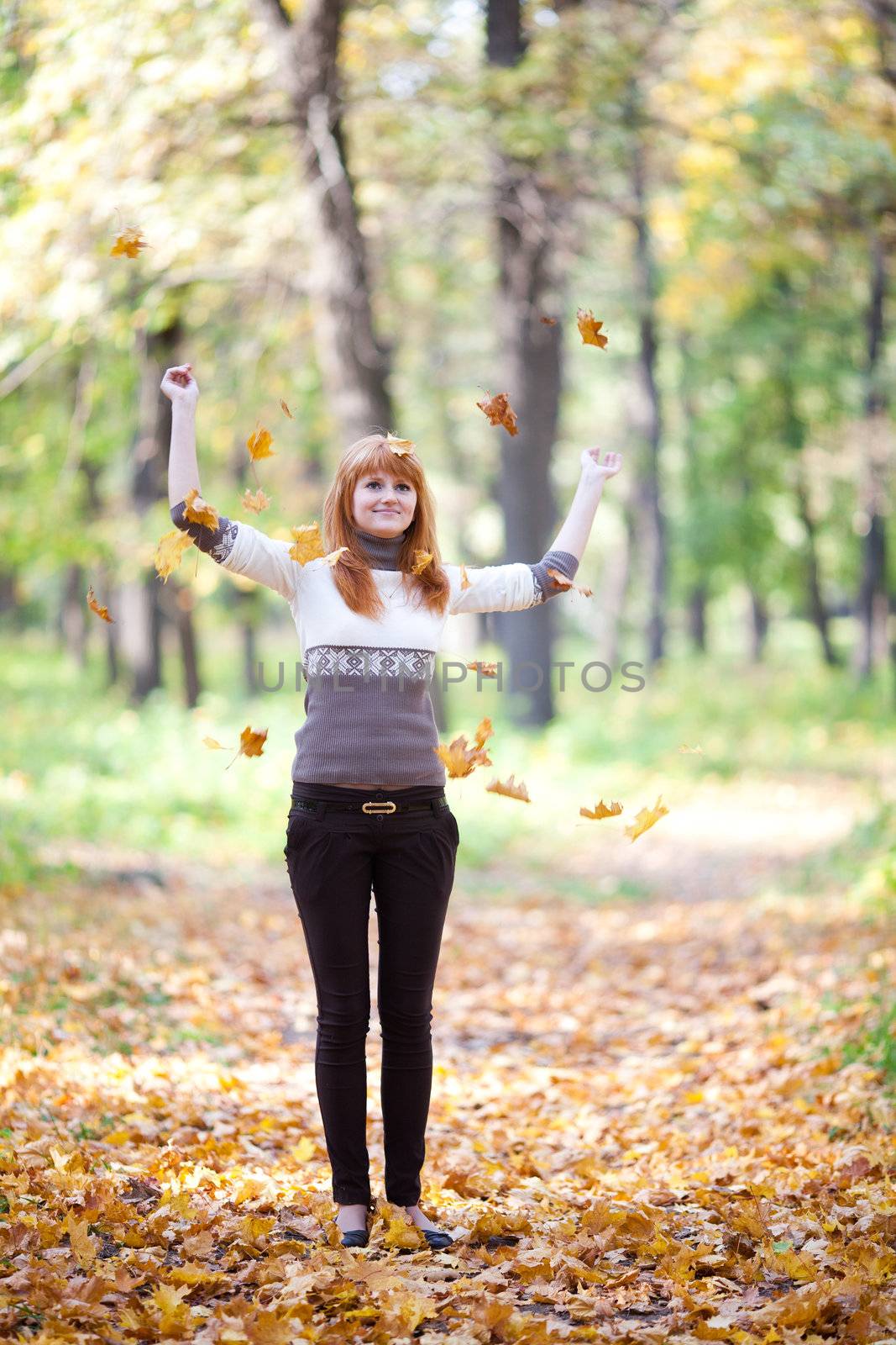 young redhead teenager throwing leaves woman in the forest   by jannyjus
