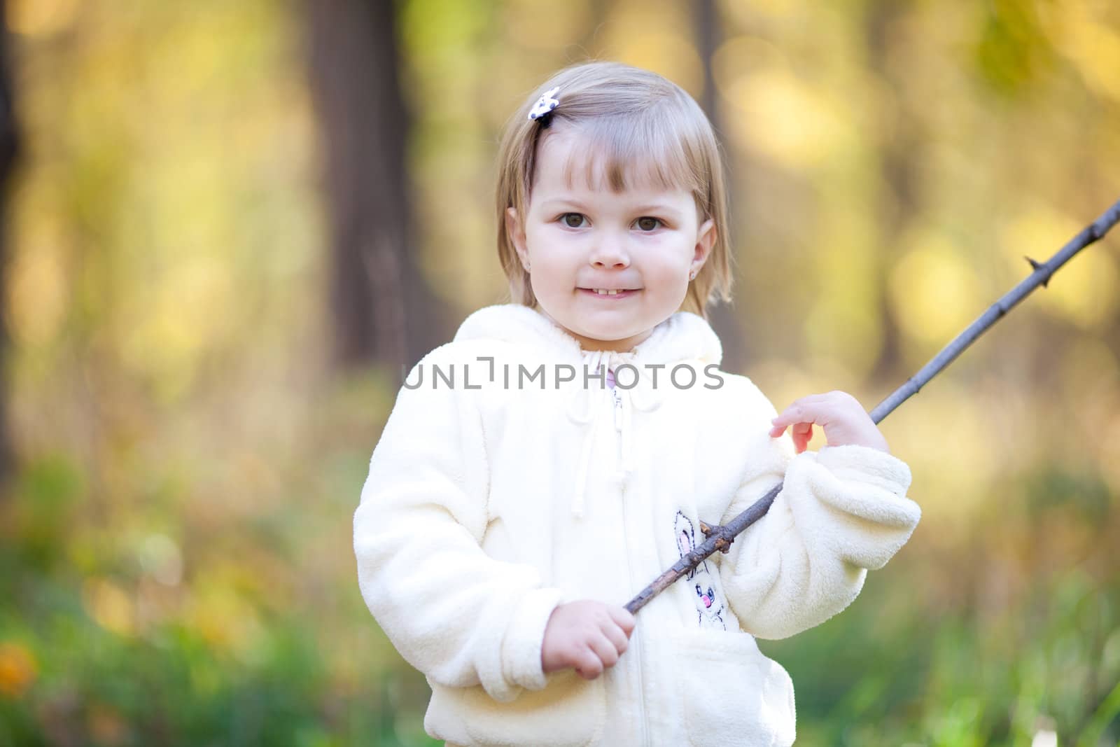 beautiful little girl with a stick on the autumn forest by jannyjus