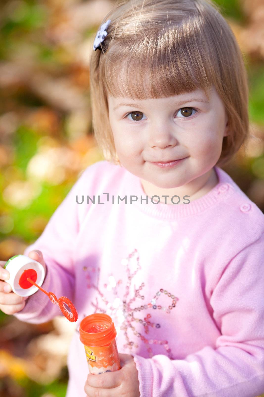 beautiful little girl making  bubble blower on the autumn forest by jannyjus