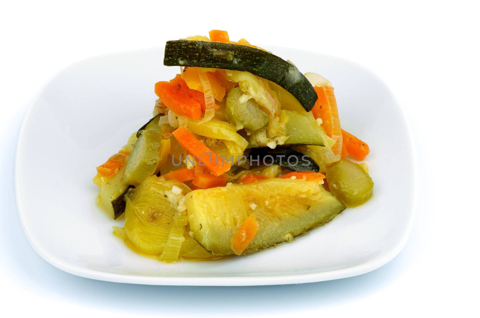 Ragout with Zucchini, Carrot, Leek and Bell Pepper on Square White Plate isolated on white background