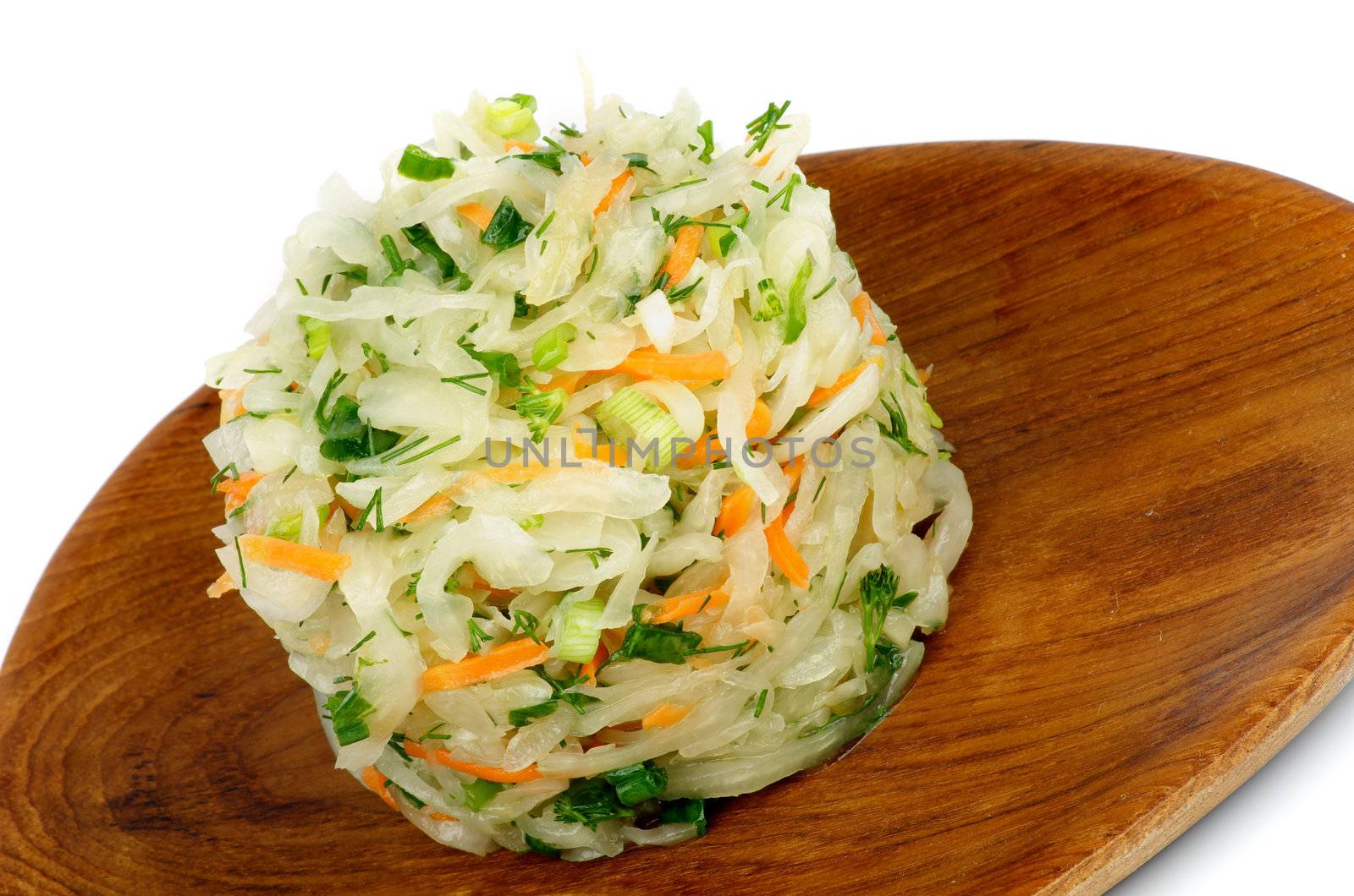 Salad of Sauerkraut with Spring Onion, Dill and Carrot on Wooden Plate closeup on white background