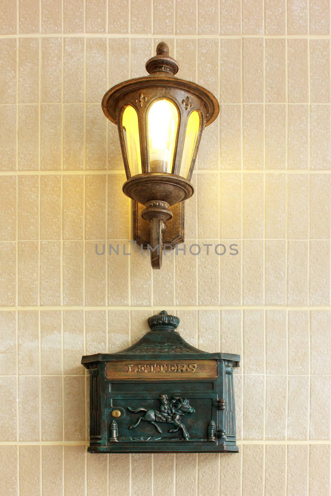 Vintage street lamp with letter box on wall