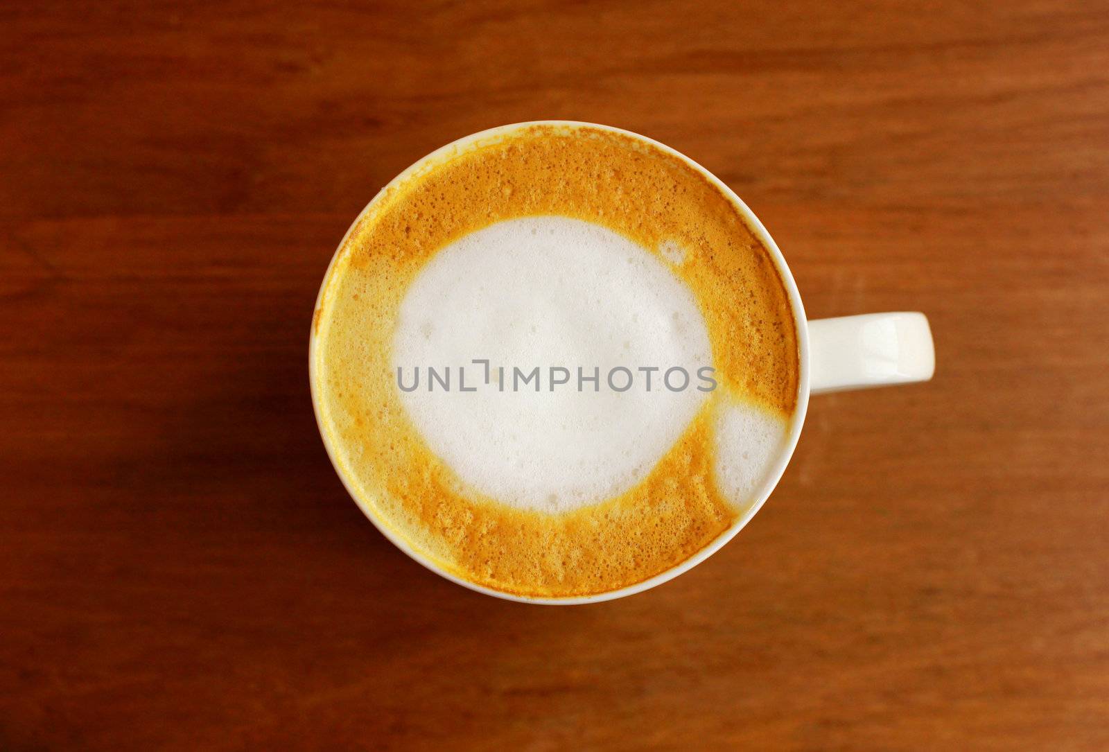 Cappuccino or latte coffee on wooden table