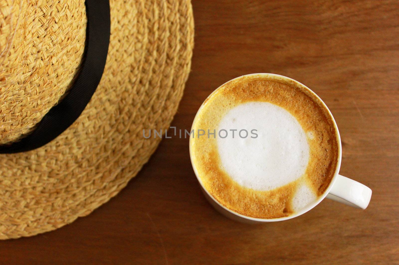 Cappuccino or latte coffee with straw hat