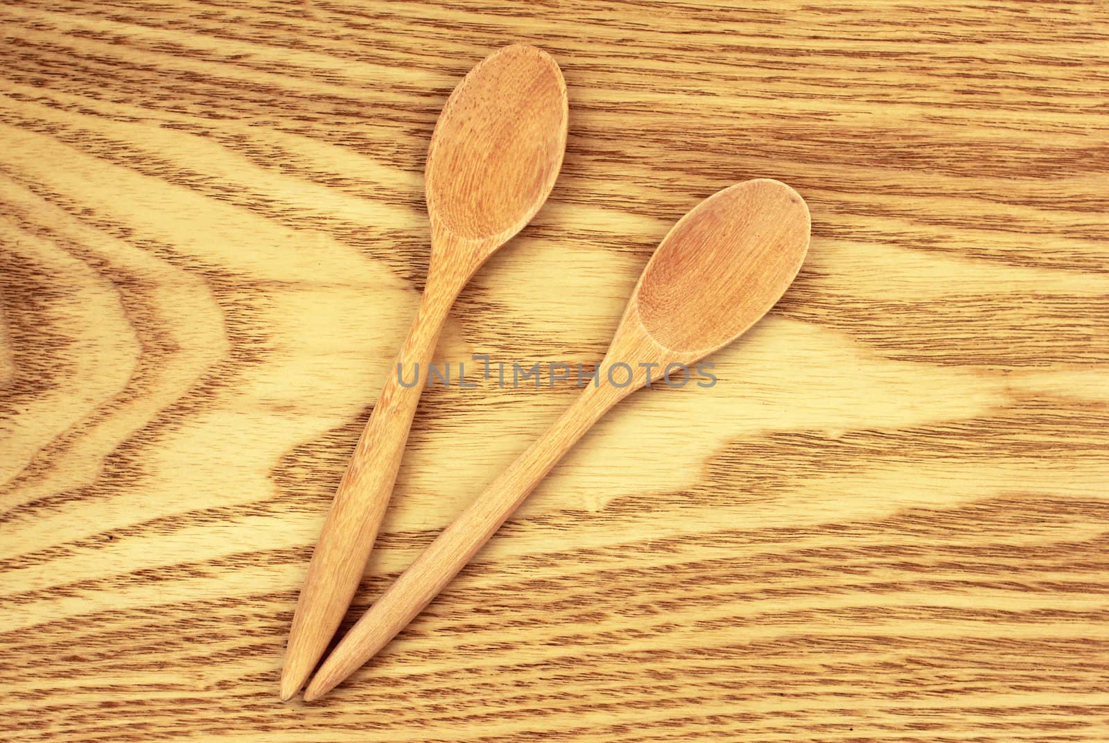 Two wooden spoons on table by nuchylee