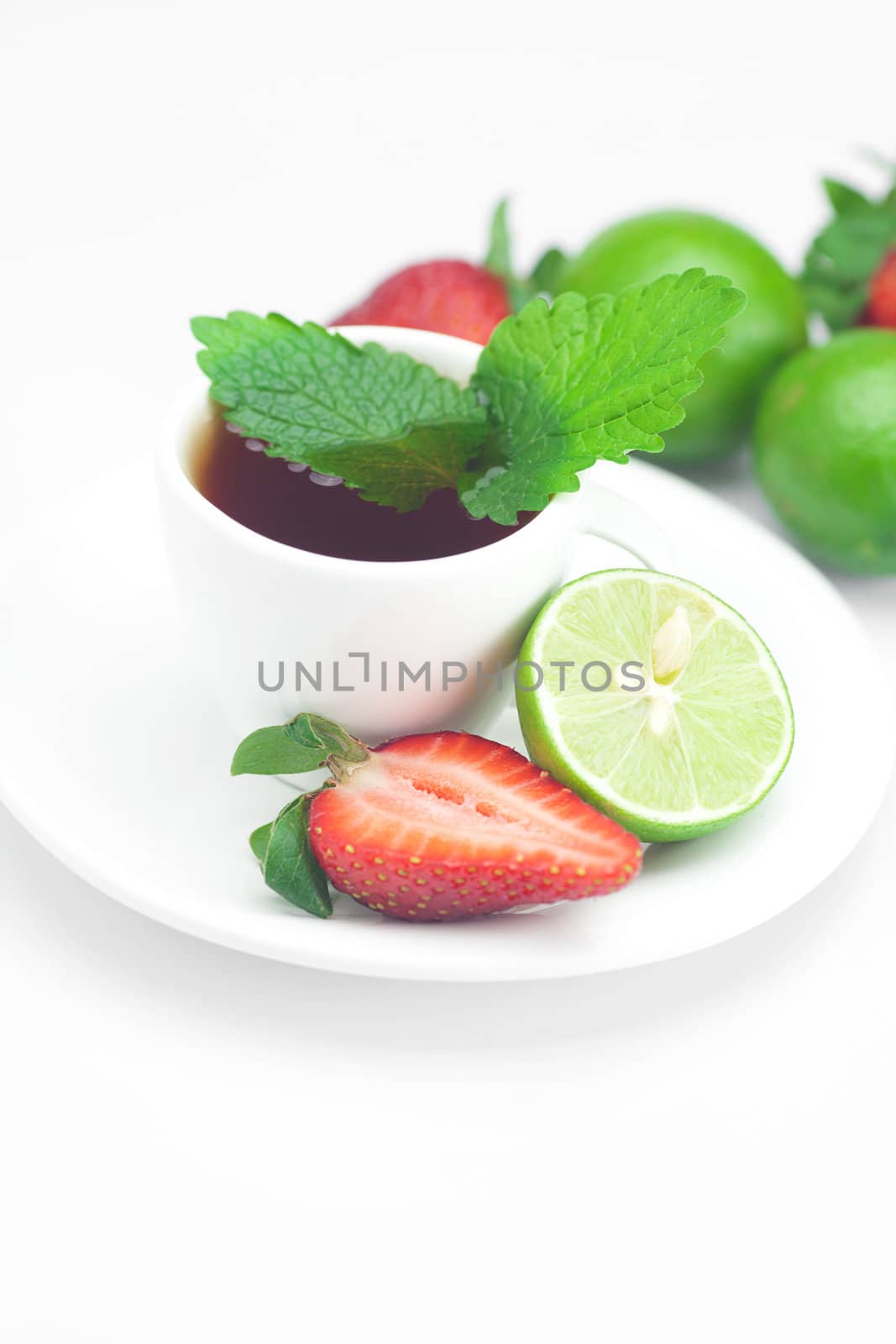 cup of tea,strawberry,mint and lime isolated on white