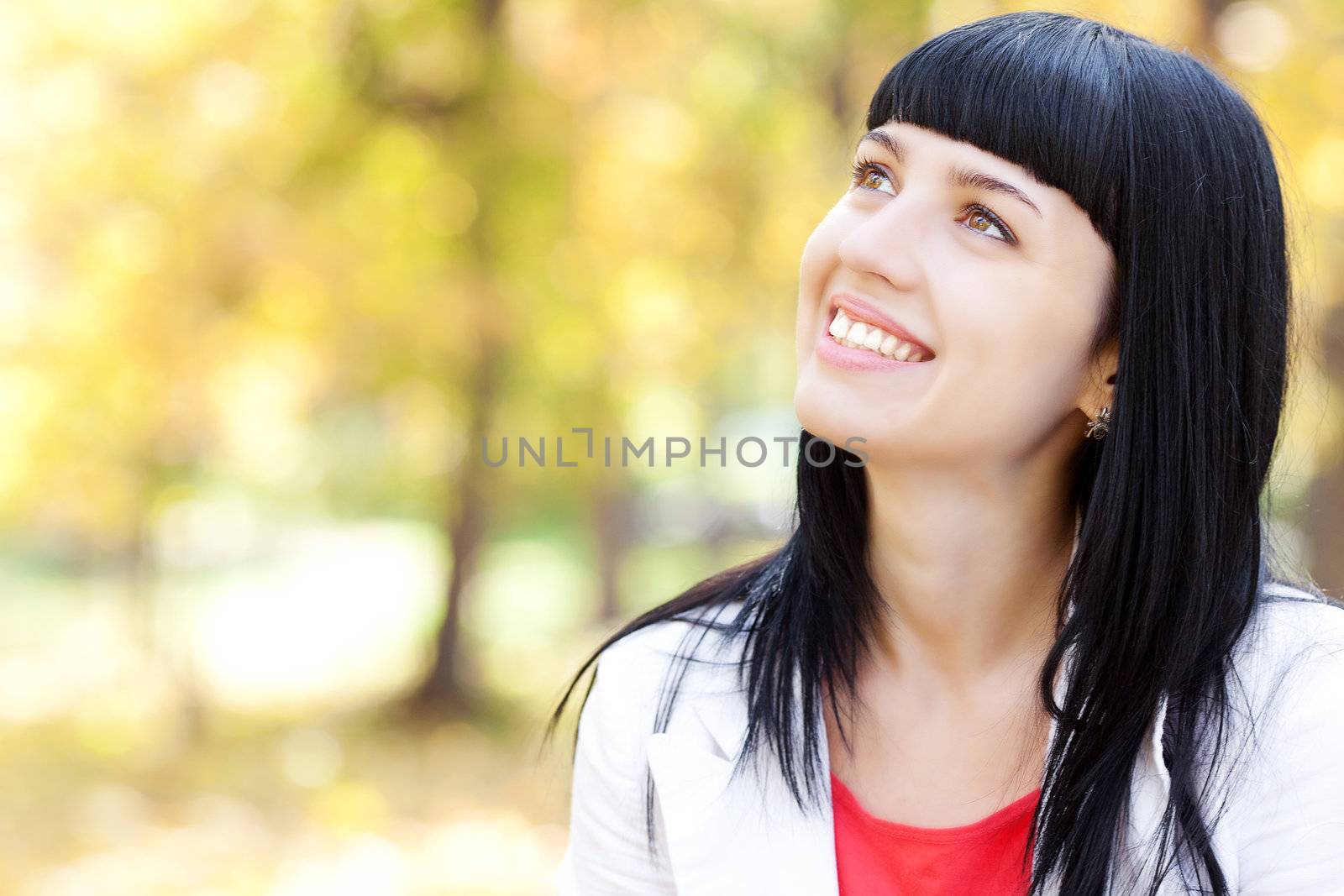 portrait of a beautiful young woman in autumn forest