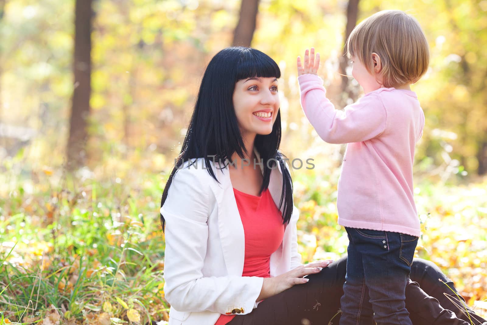 beautiful young mother and her daughter on the autumv forest by jannyjus