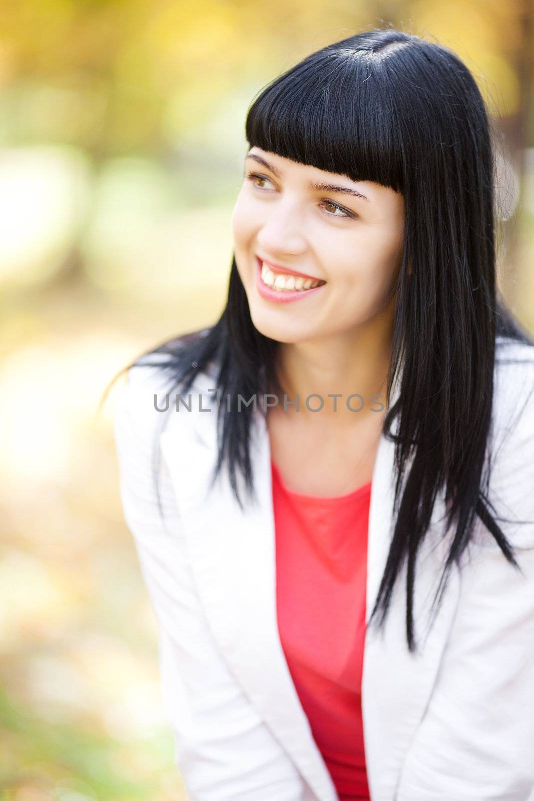 portrait of a beautiful young woman in autumn forest
