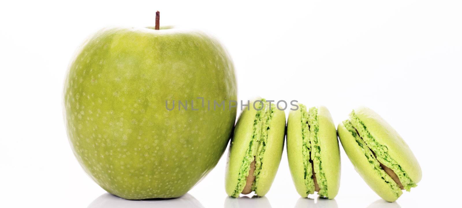 green apple with macaroons on white background, panoramic