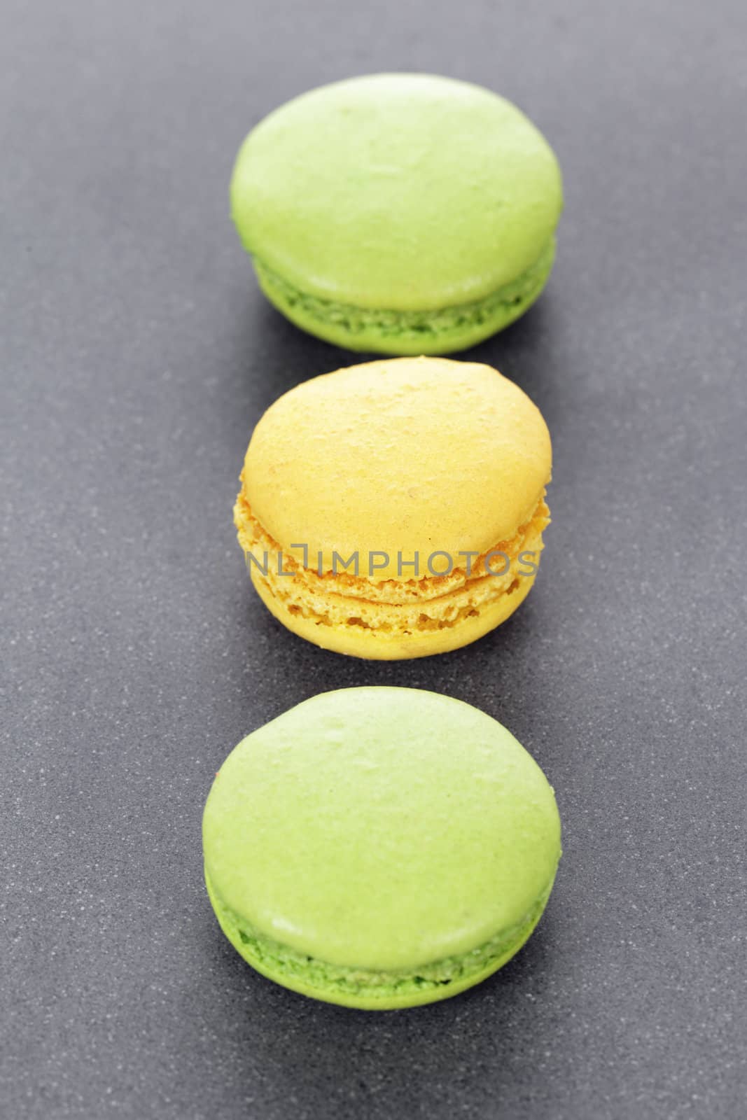 three green and yellow macaroons in kitchen