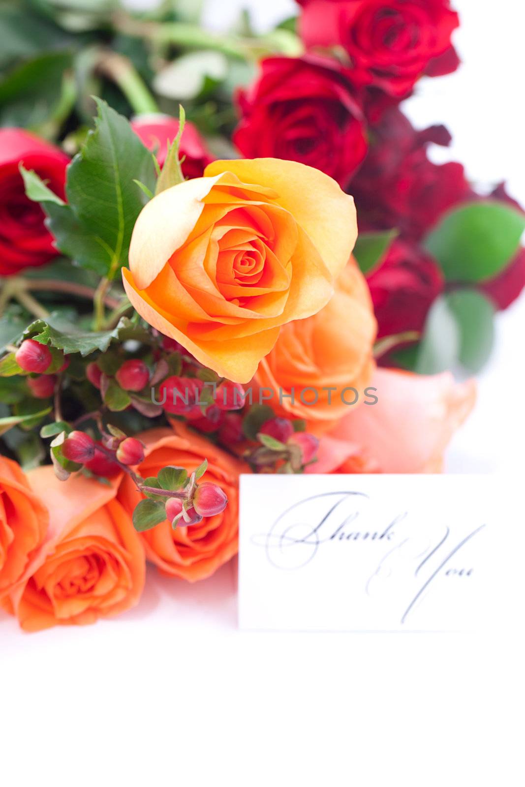 bouquet of colorful roses and a card with the words thank you