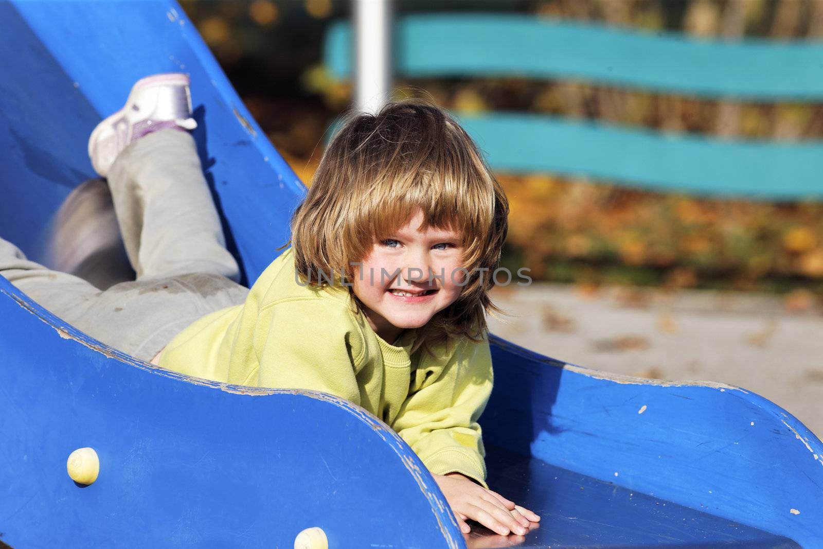 portrait of child playing on colorful playground 