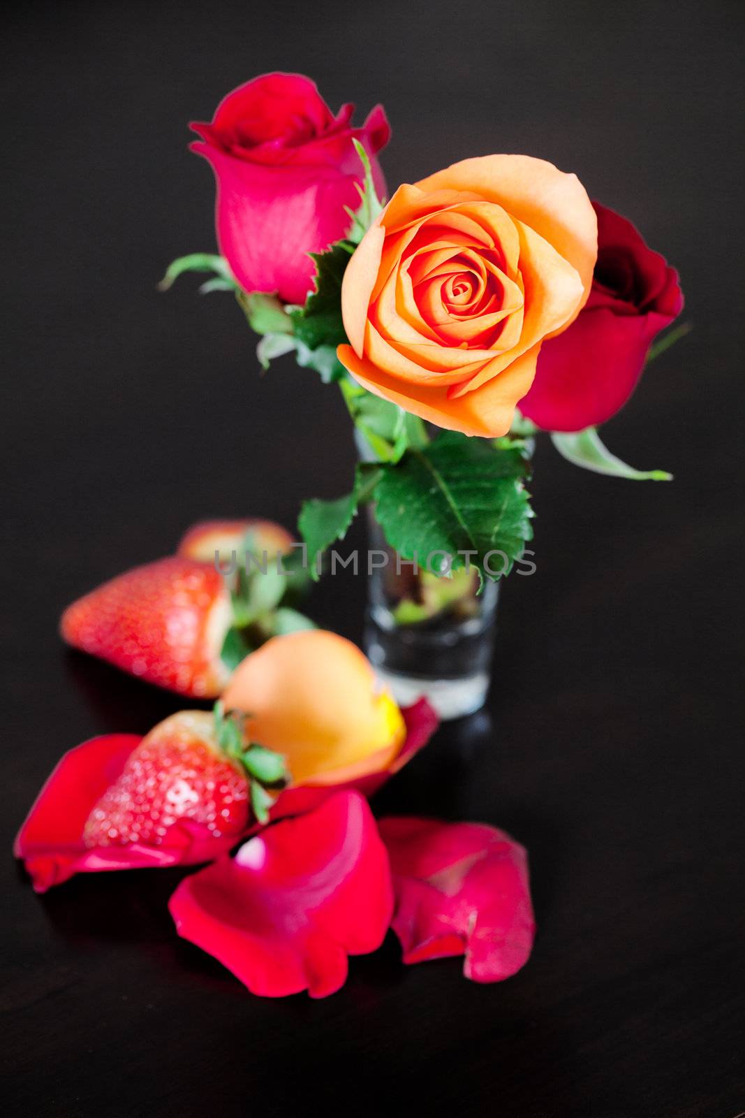 bouquet of colorful roses in a vase and strawberry on a wooden t by jannyjus