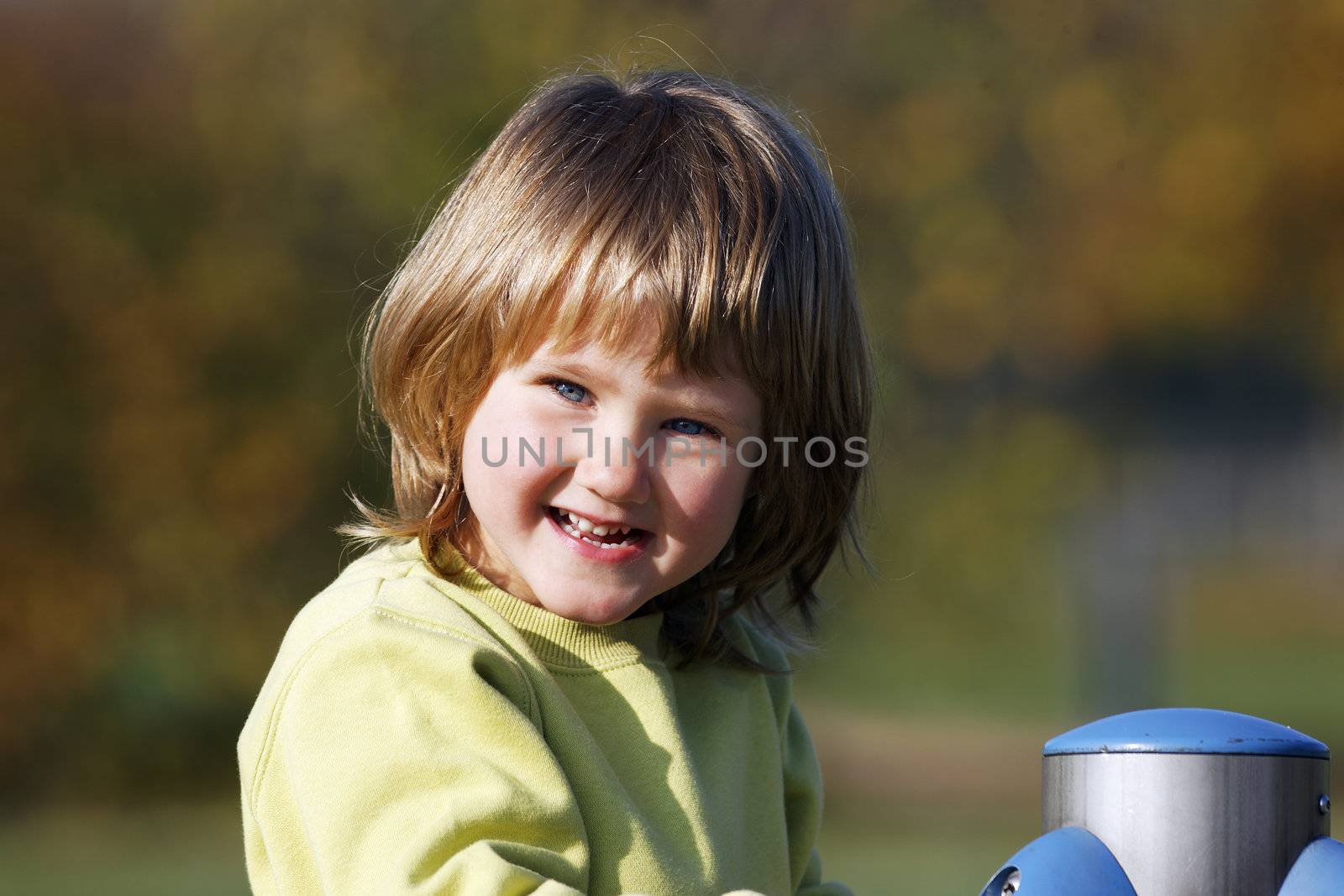portrait of child playing on colorful playground 