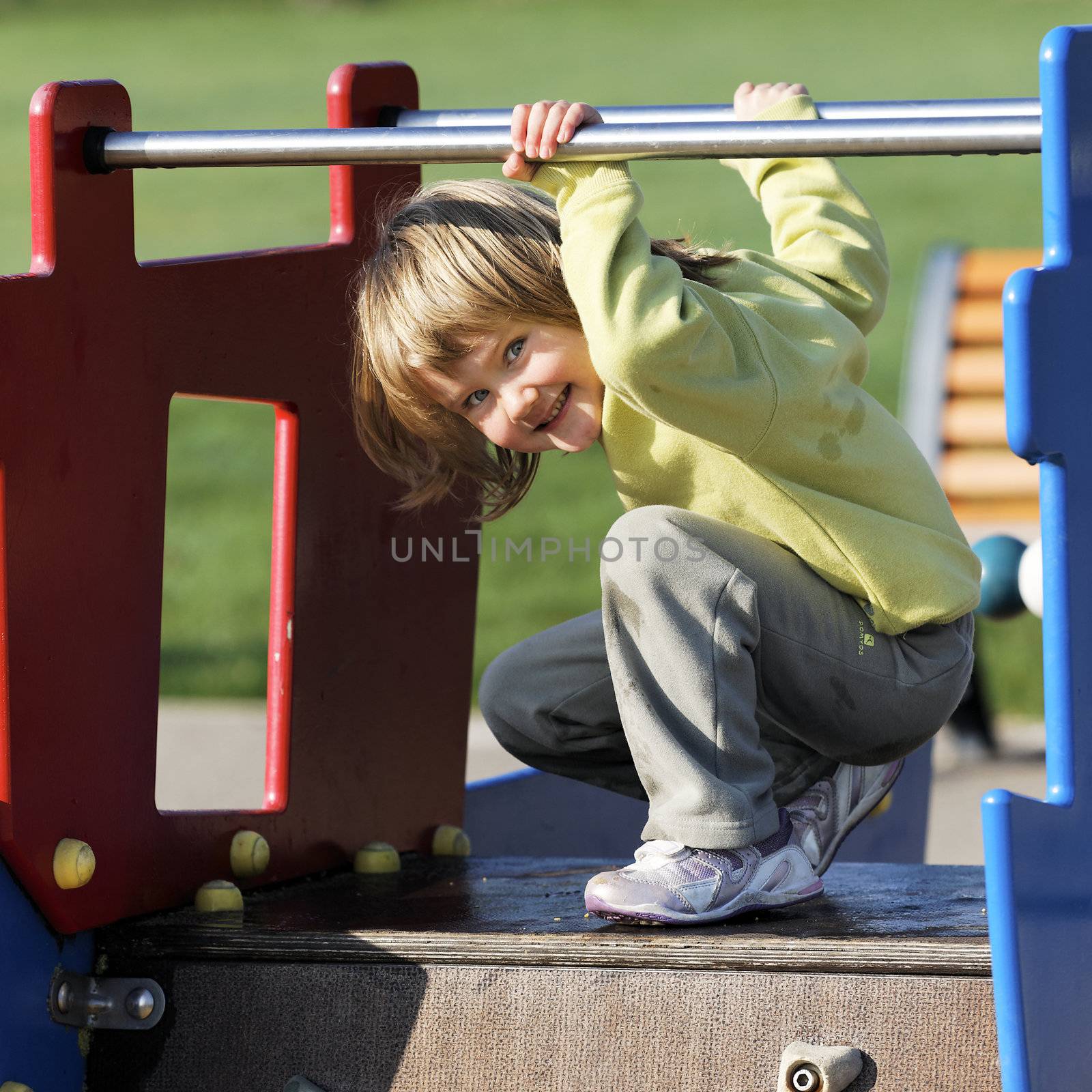 child playing on colorful playground in a park