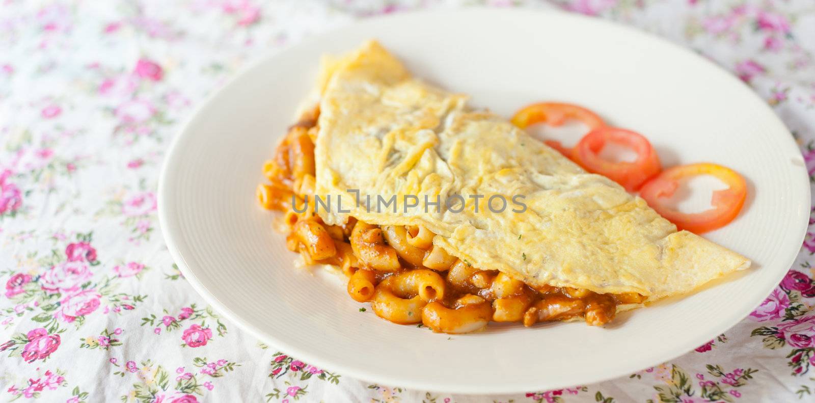 Fried macaroni with tomato sauce wrapped with omelette thai food