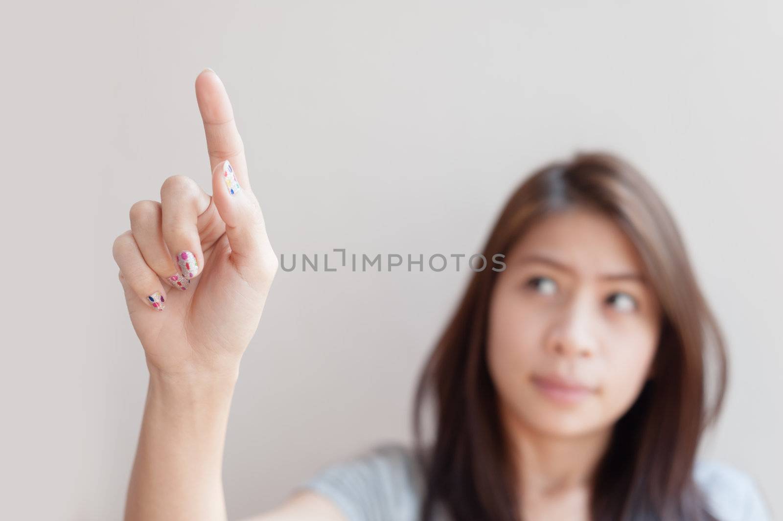 asian woman pressing an imaginary button empty space for buttons