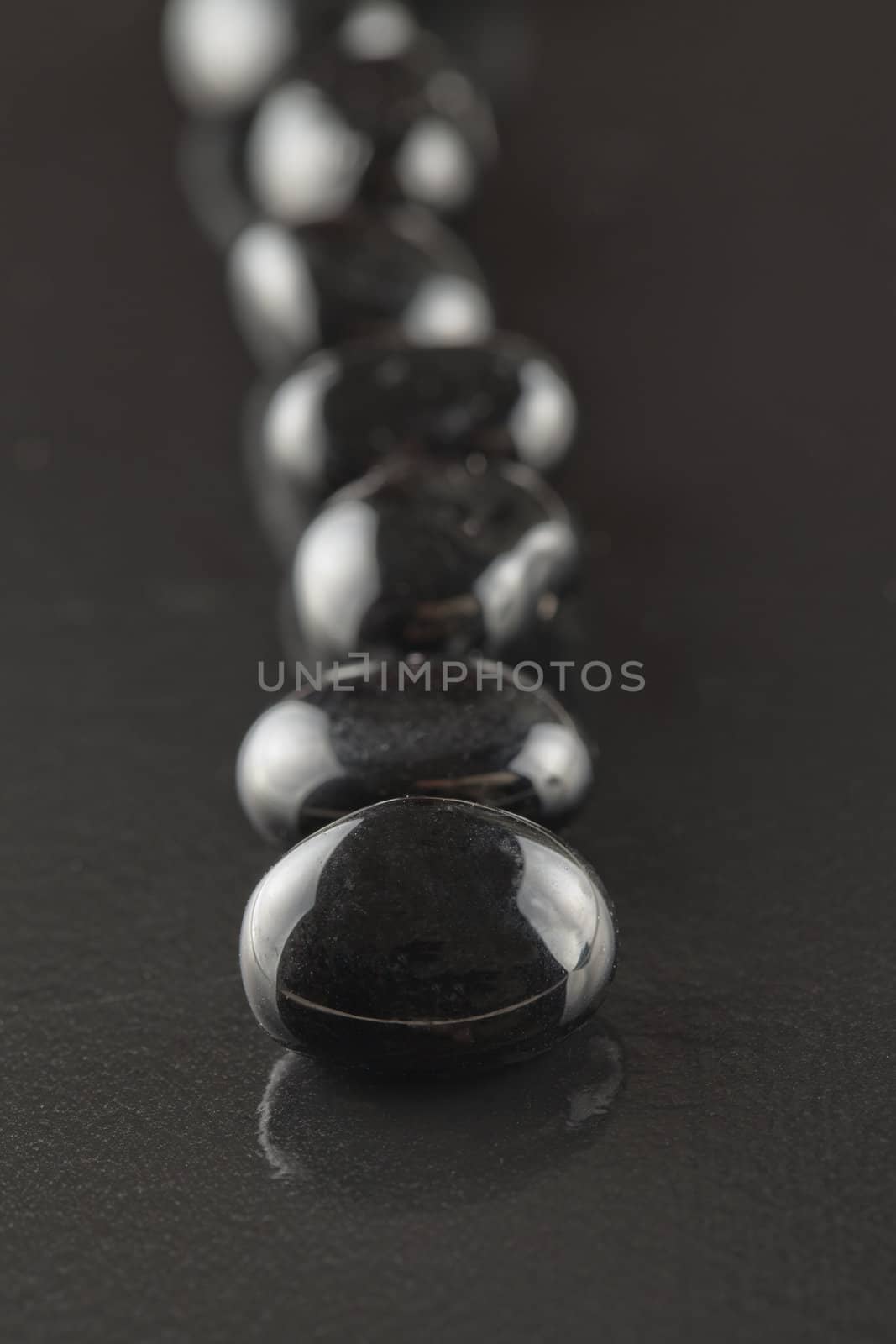 Little black stones over a black background