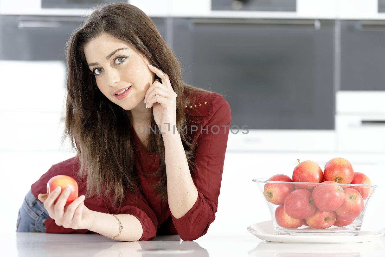 Woman holding an apple by studiofi