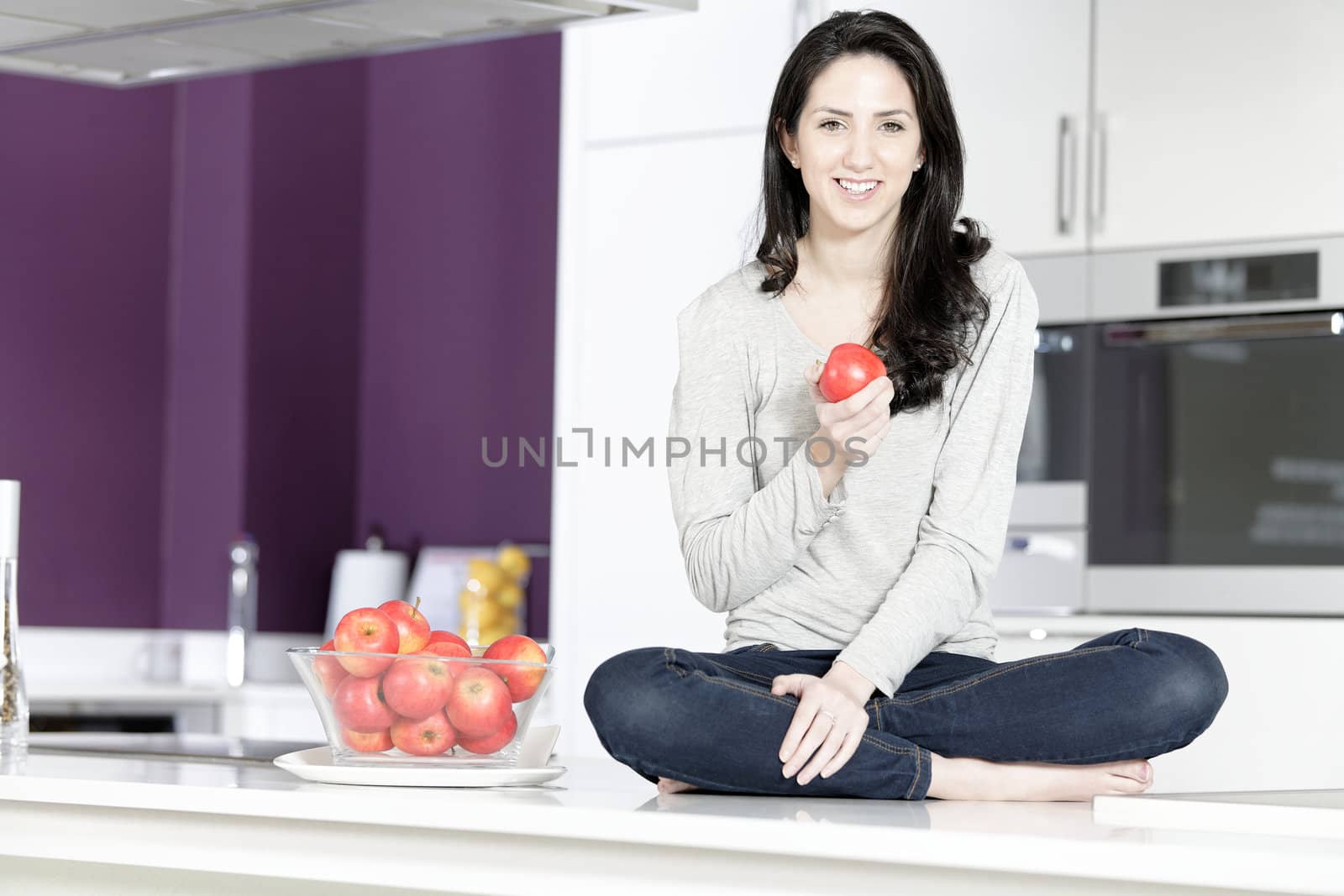 Woman holding an apple by studiofi