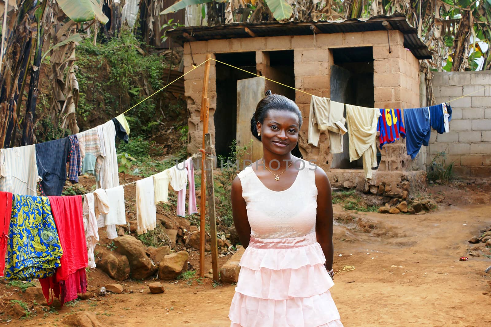Beautiful young African woman in backyard with clothesline