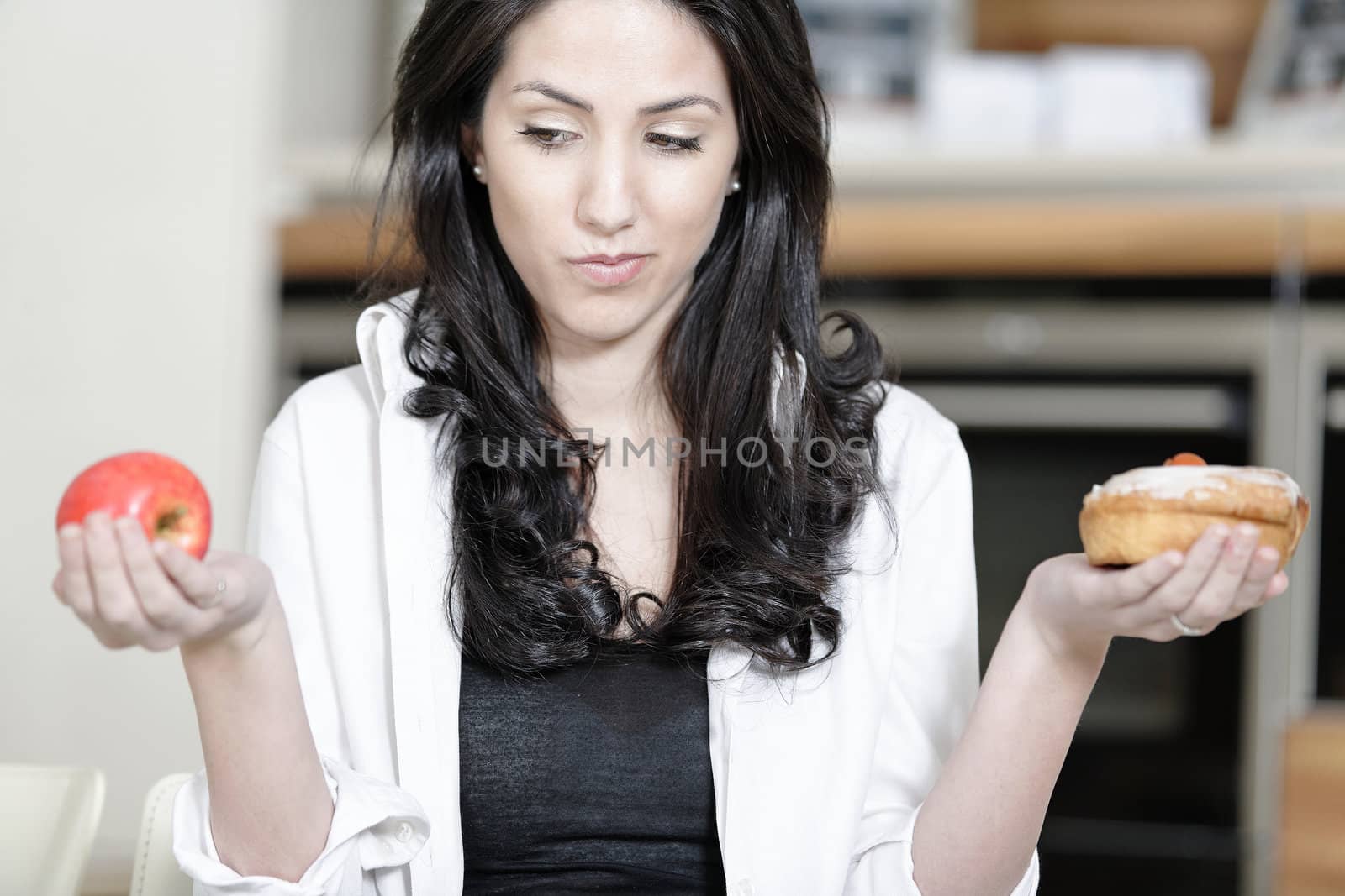 Woman choosing cake or fruit by studiofi