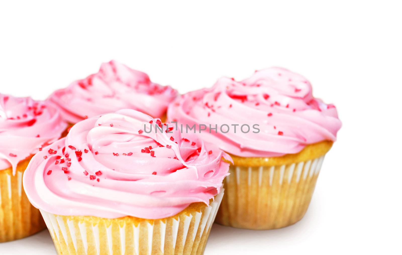 Sweet vanilla cupcakes with pink frosting over white
