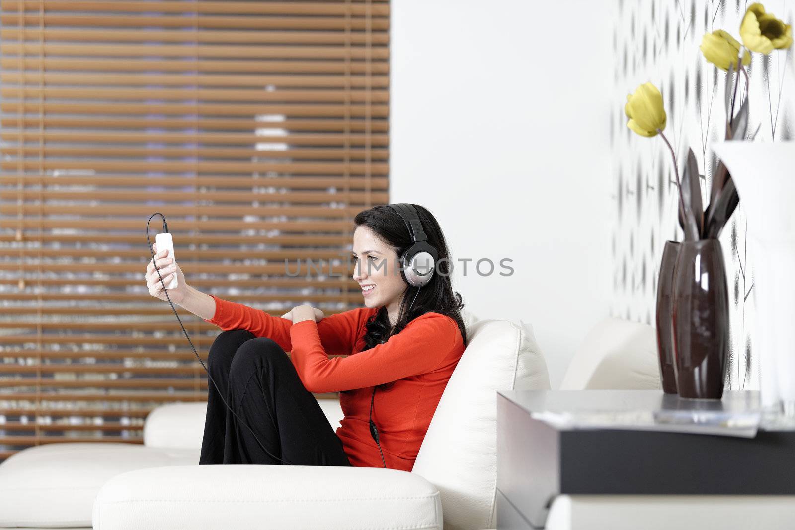 Woman listening to music by studiofi