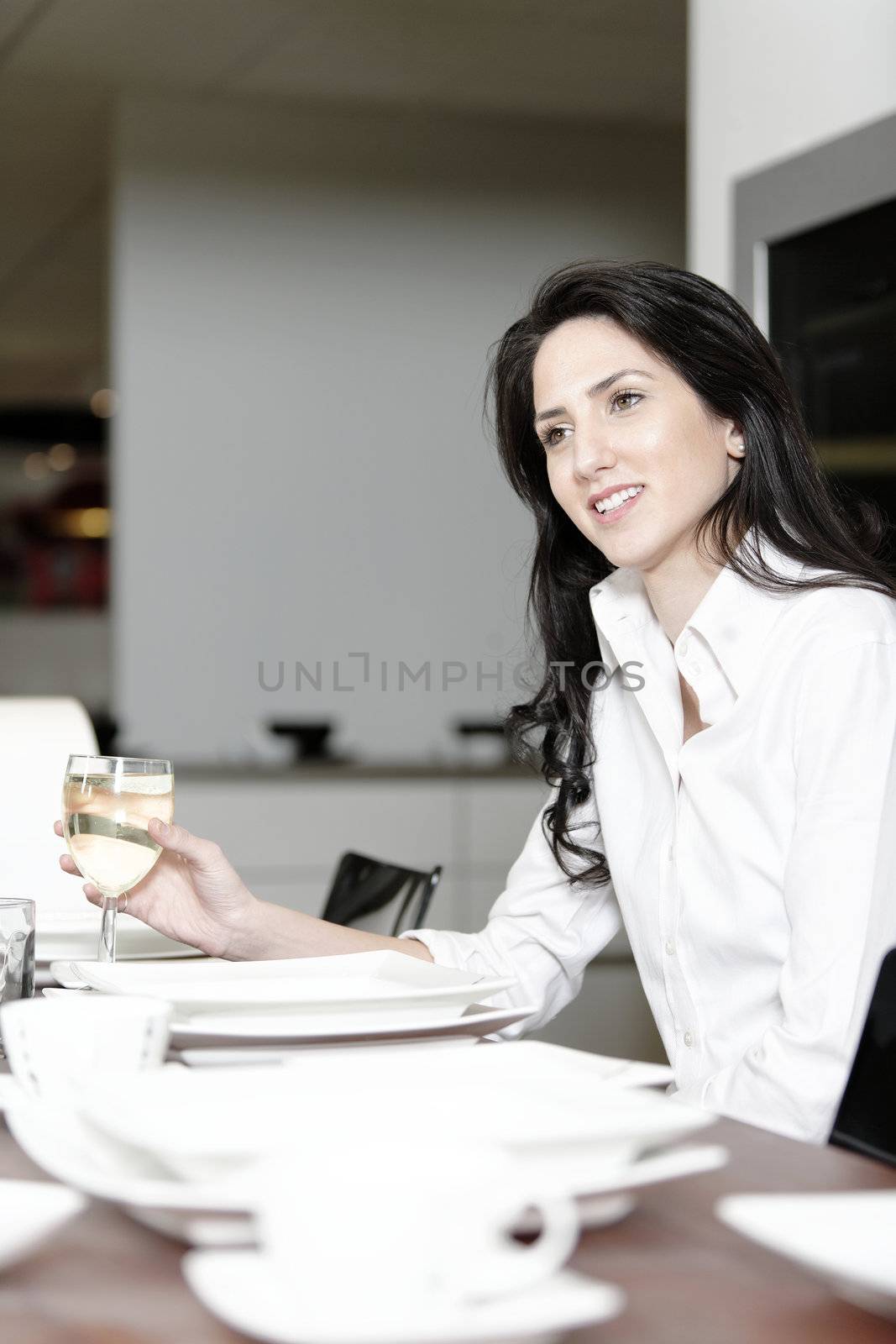 Woman at the dinner table by studiofi