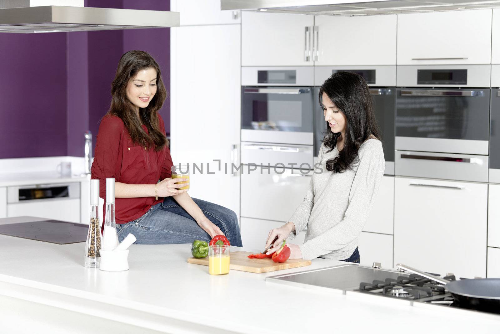 Two friends preparing food by studiofi