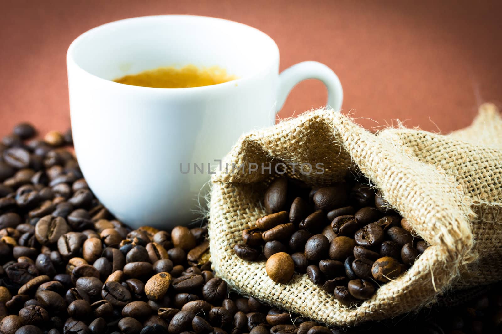 Coffee beans in a juta bag and cup