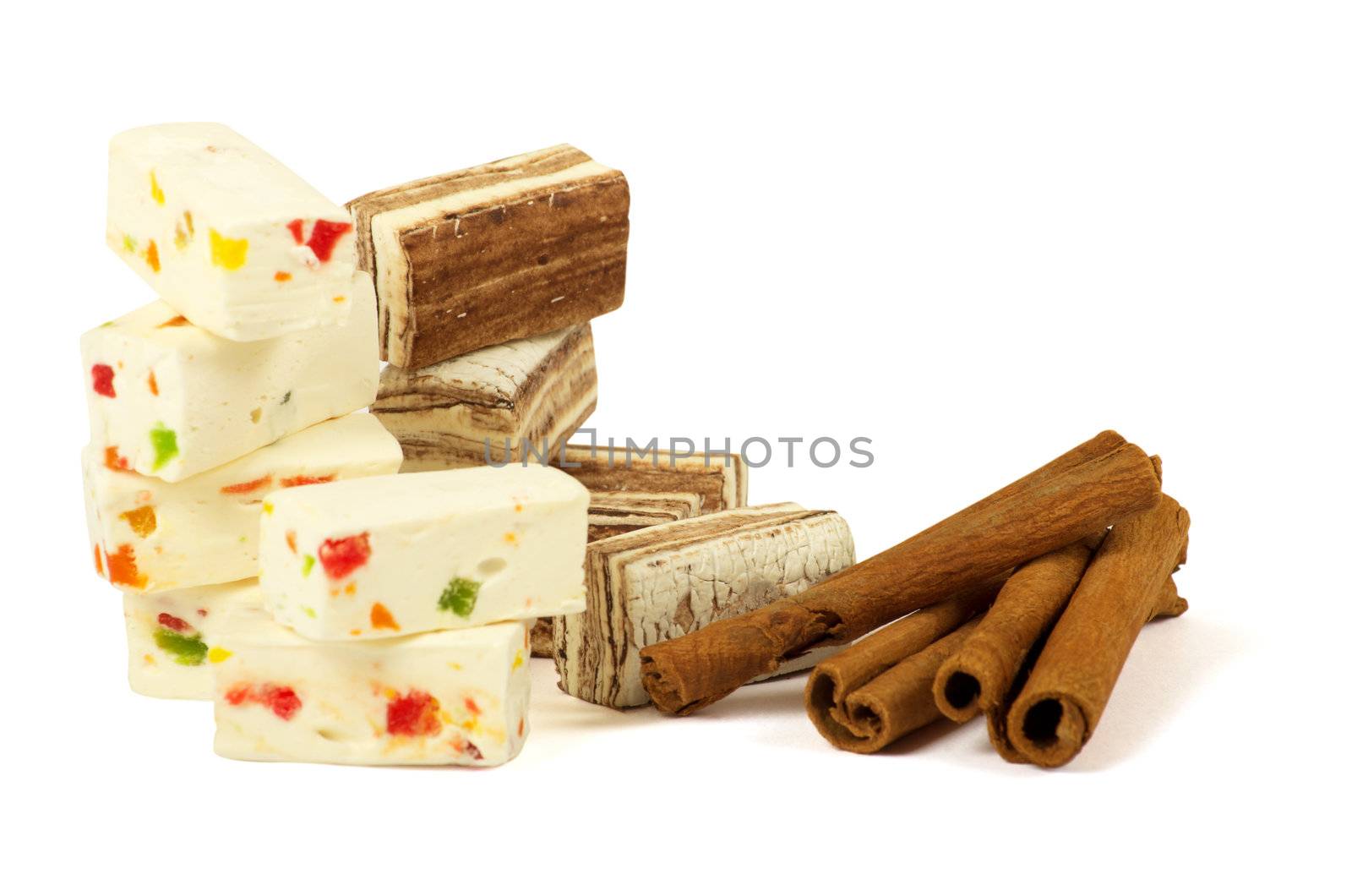 Sweets and cinnamon sticks isolated on white background