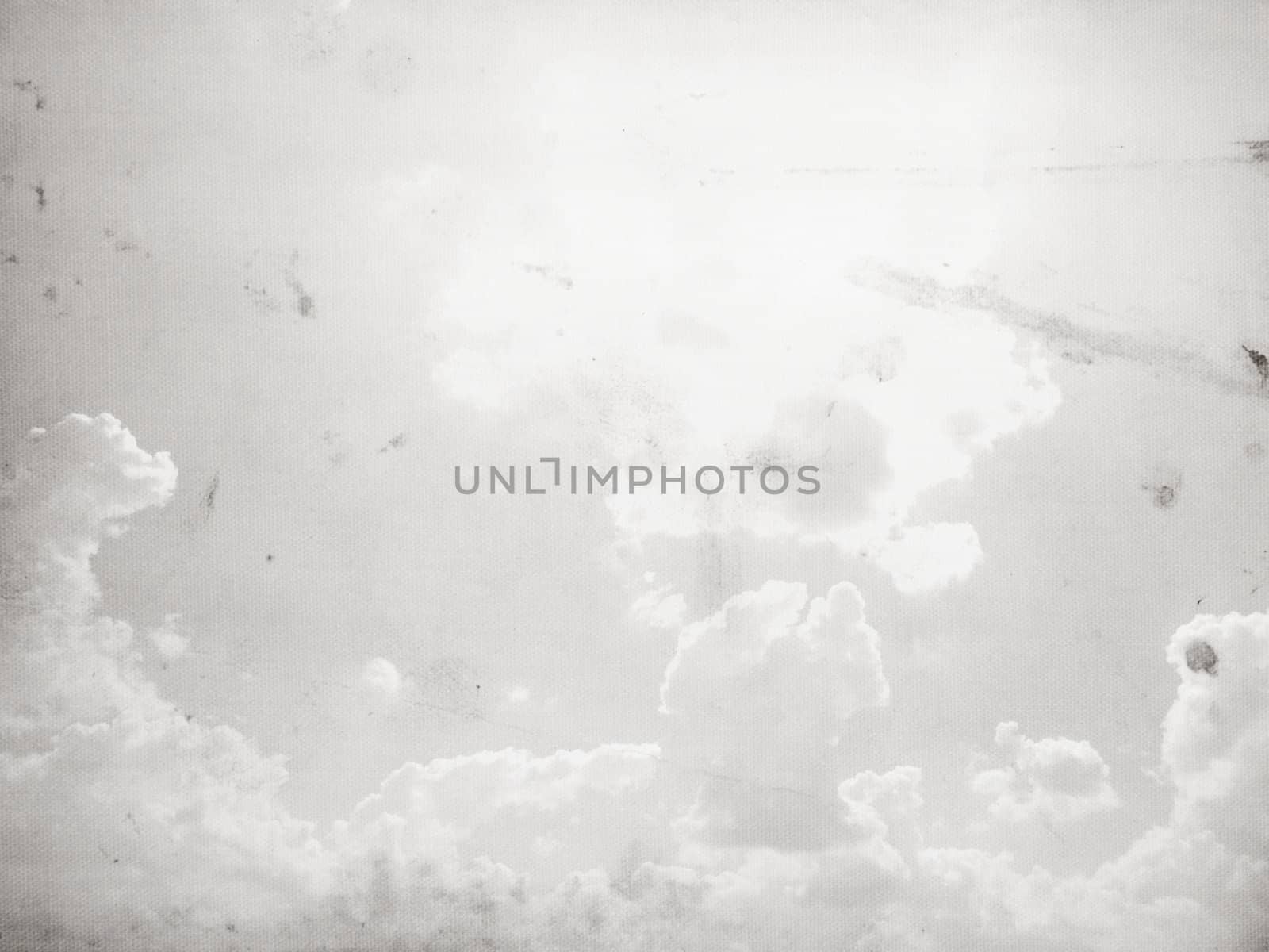 Fog and clouds on a vintage, textured paper background with a color gradient.