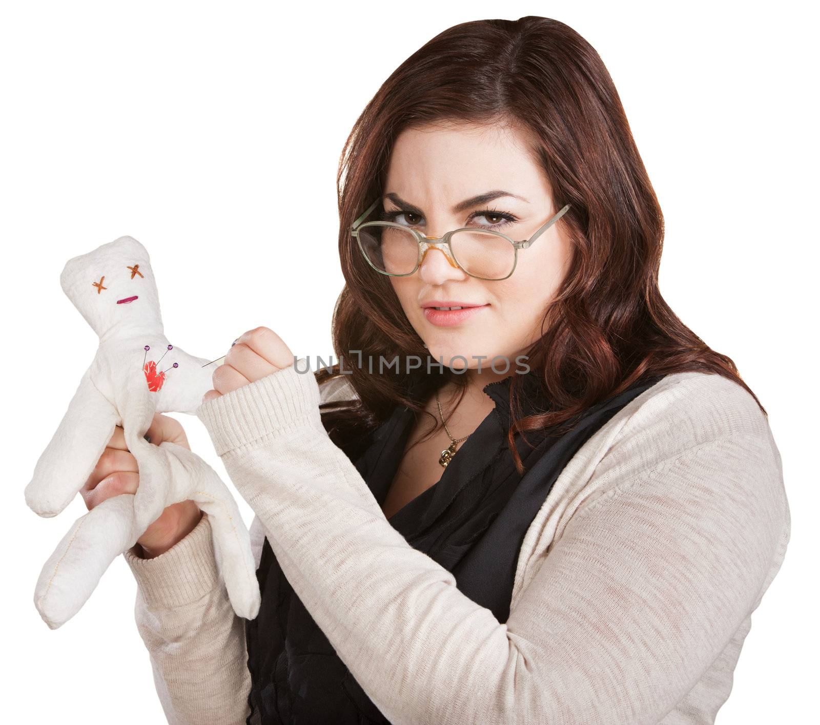 Mad woman with eyeglasses sticking doll with needle