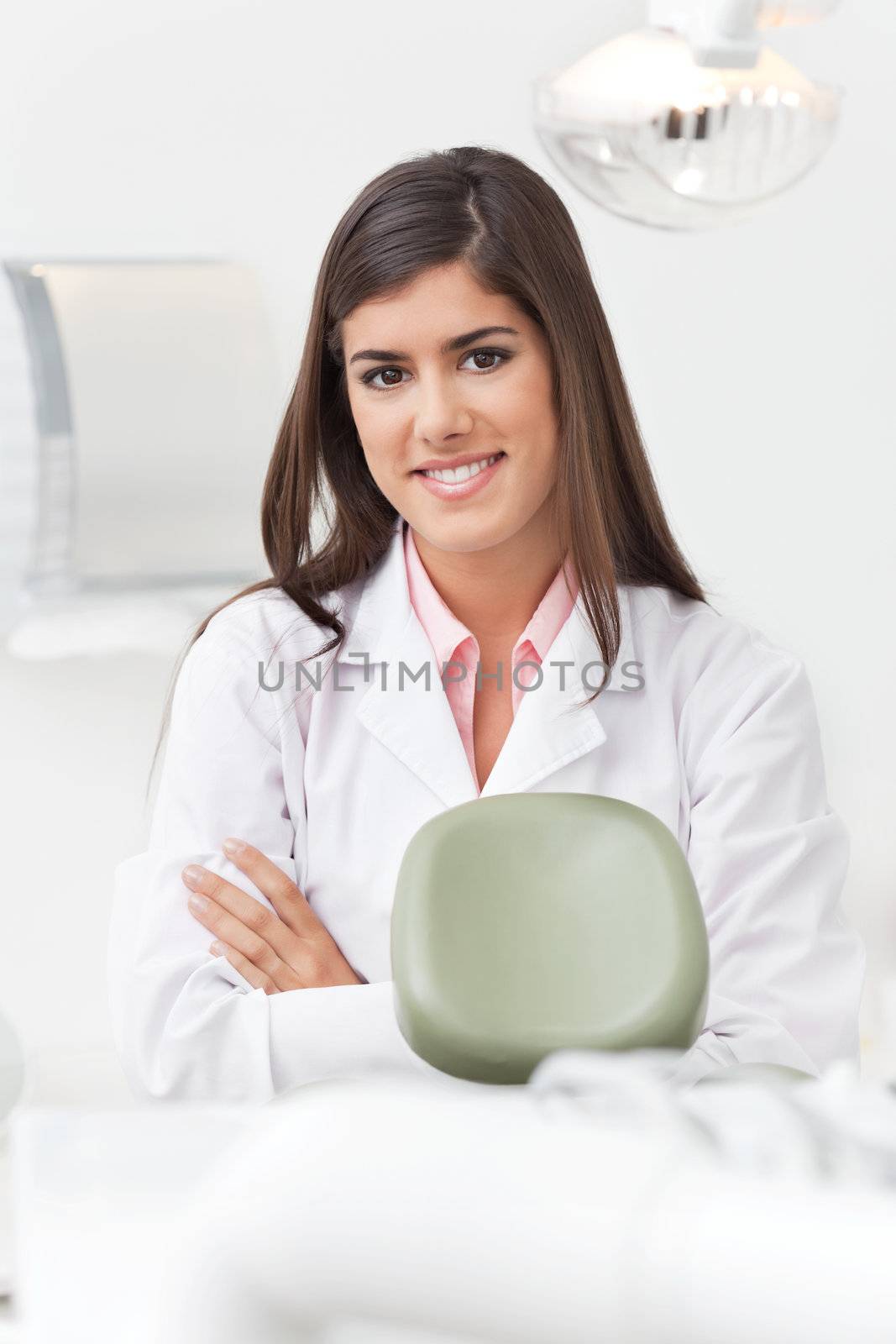 Portrait of female dentist by leaf