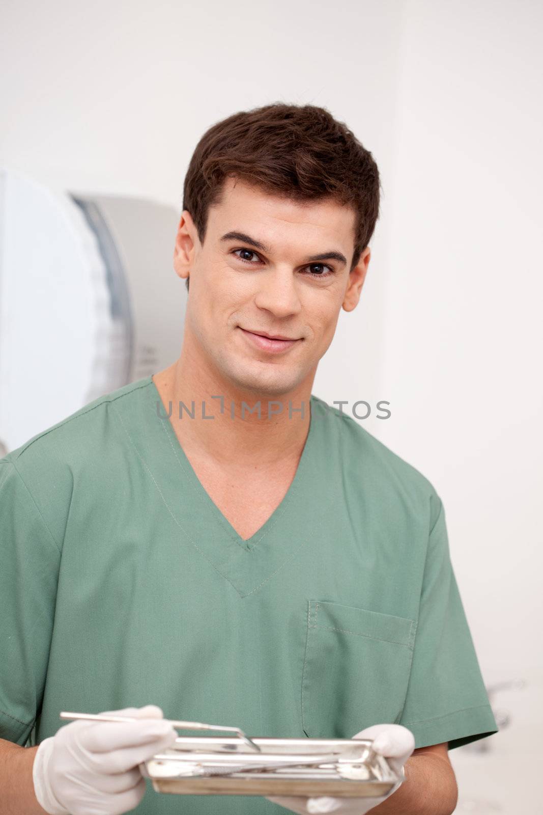 A happy smiling man dentist looking at the camera with a smile