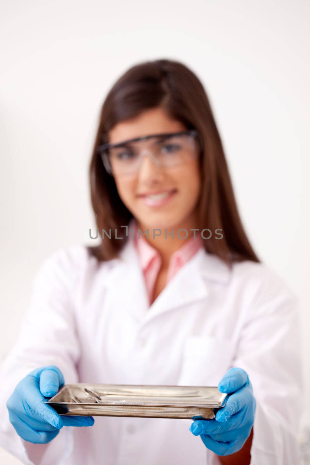 Dentist holding sterile tray of dentistry tools