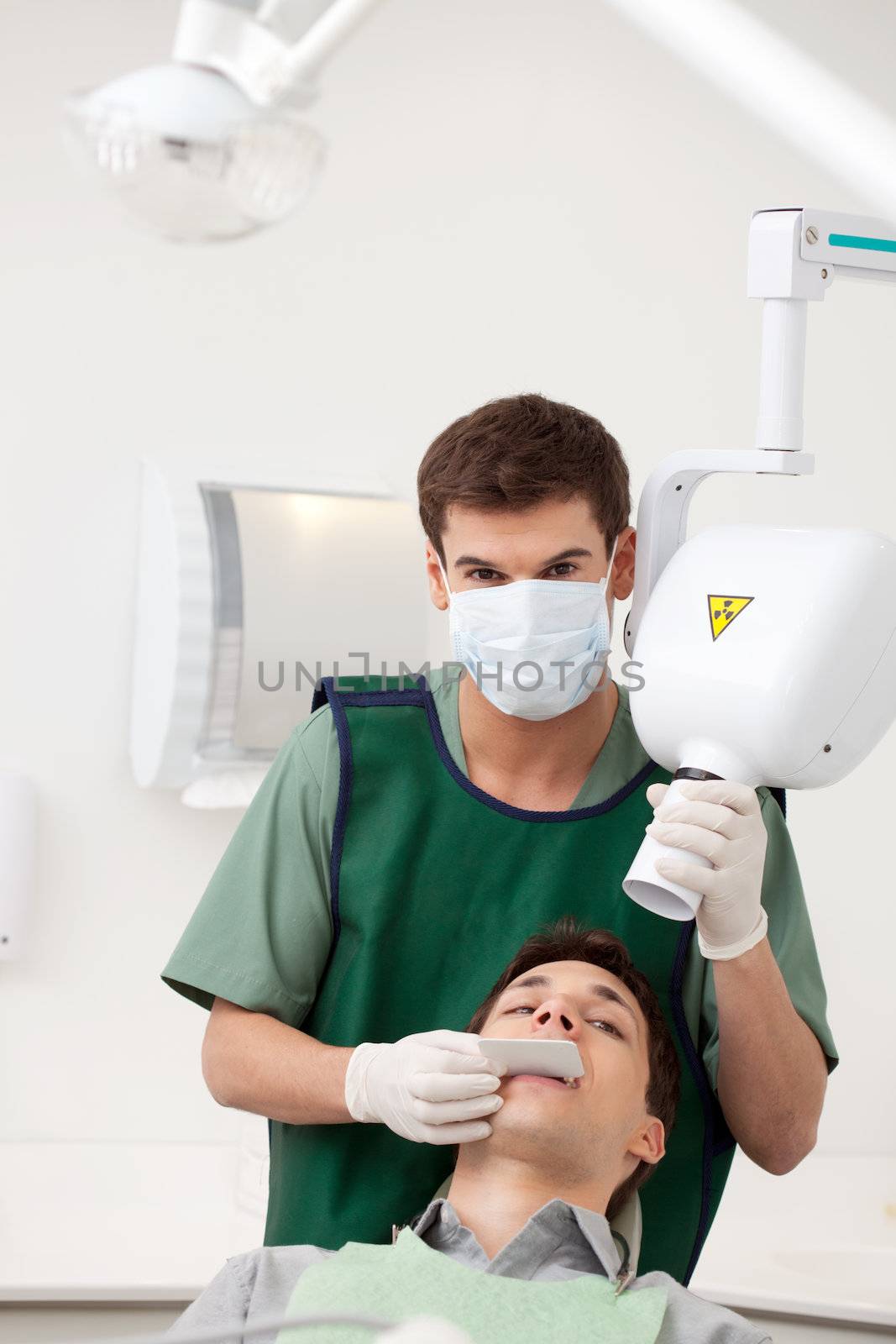 A young man dentist preparing an x-ray