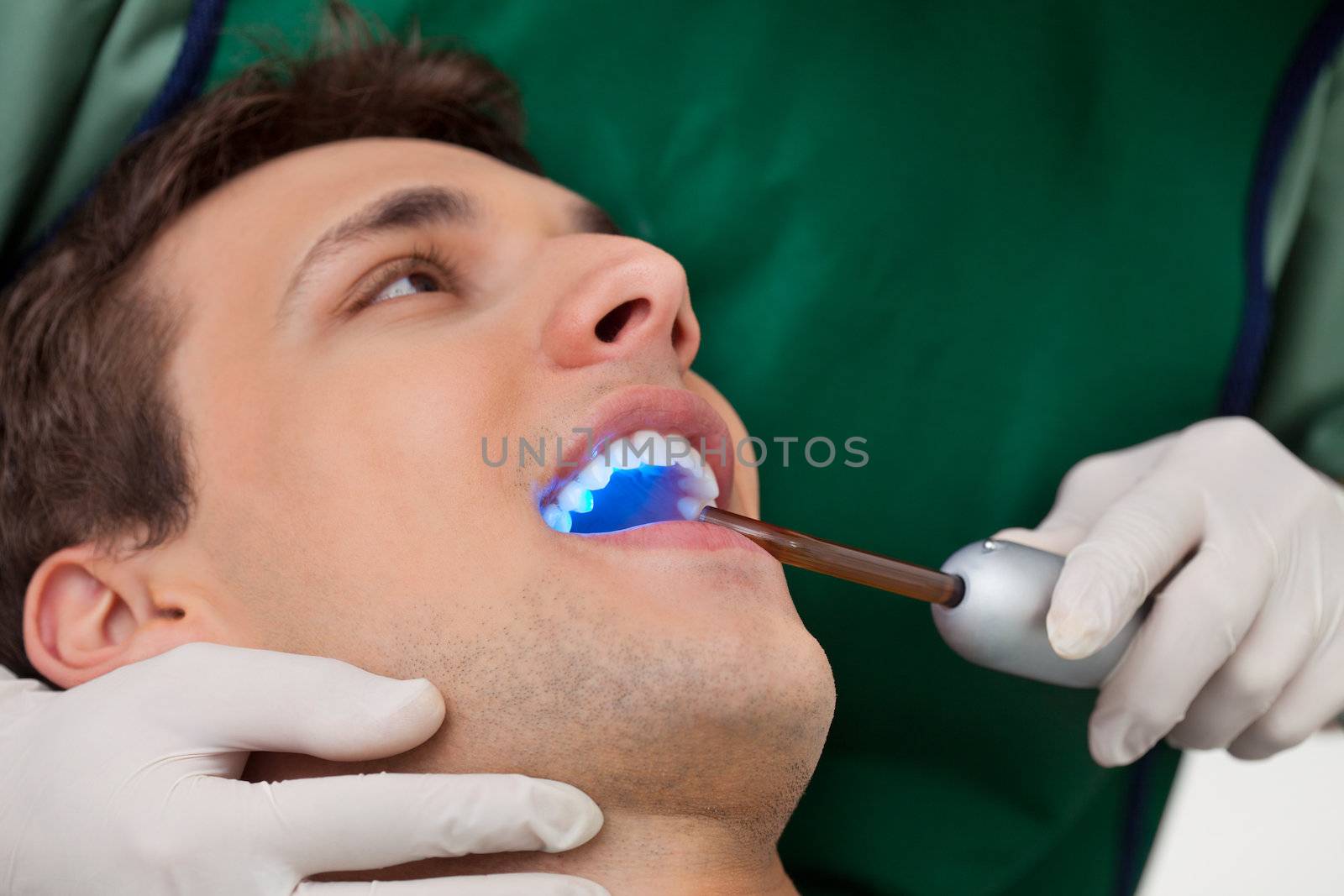 Dentist with UV Light by leaf