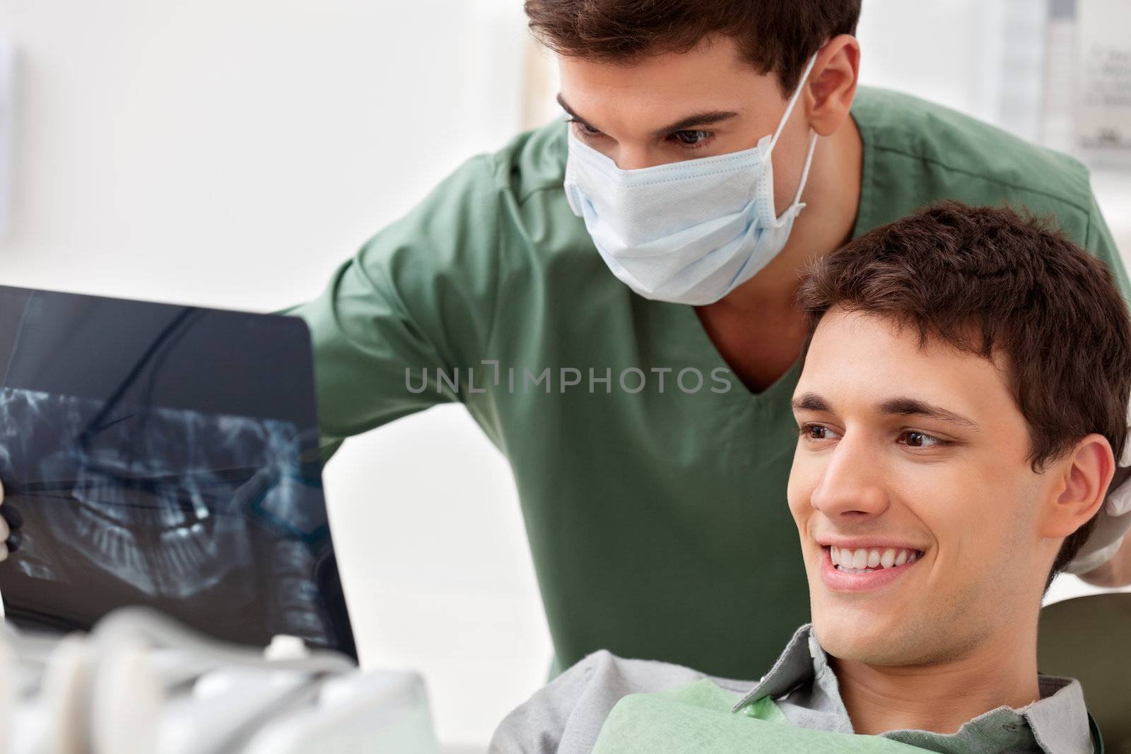 Patient looking at his tooth x-ray by leaf