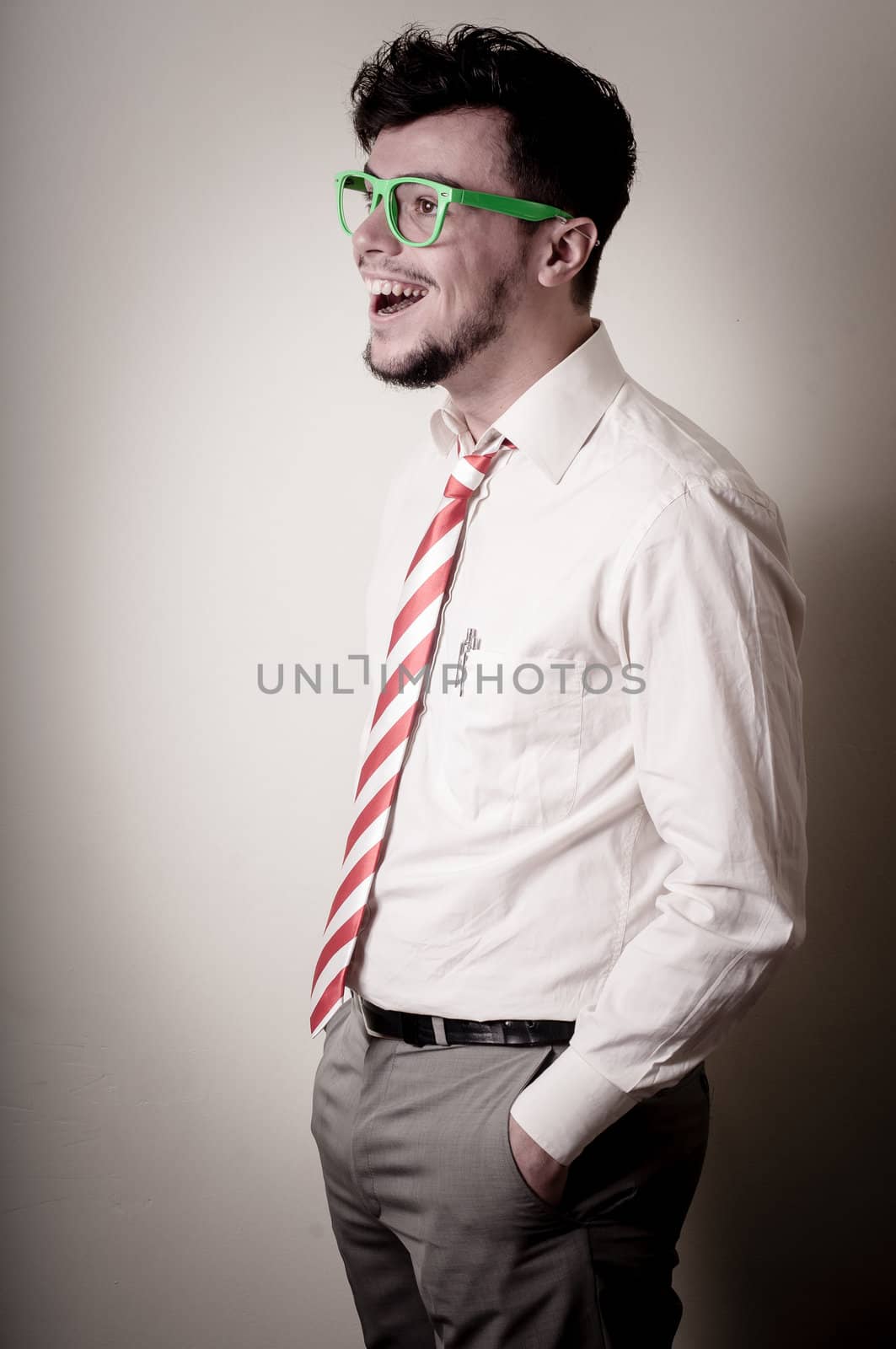 hipster stylish businessman with green eyeglasses on gray background