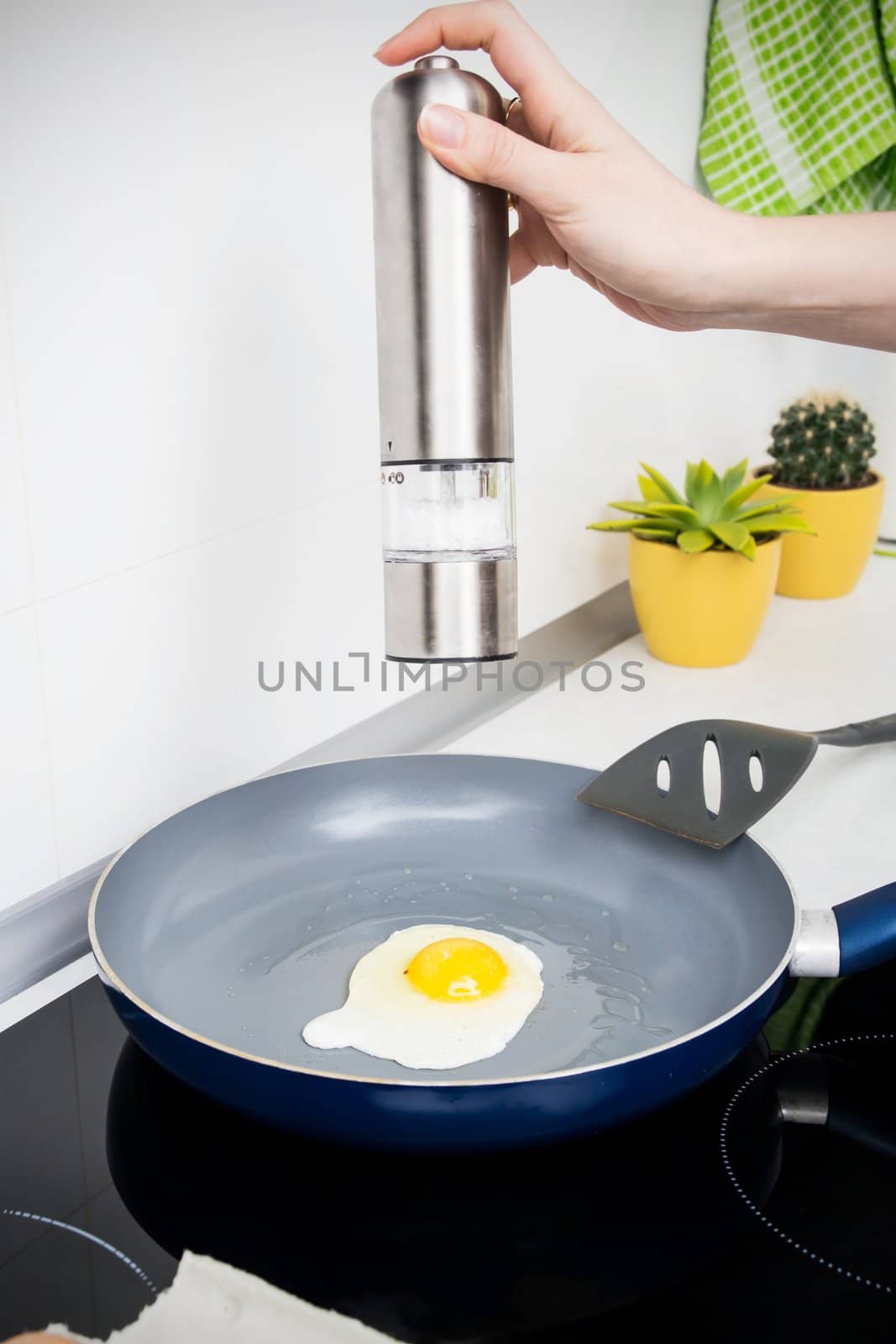 Woman salt egg in a frying pan