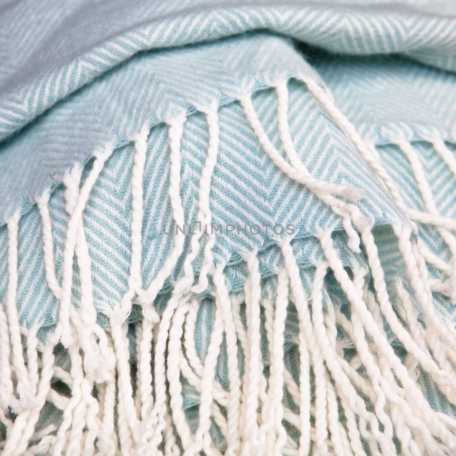Close up of the tassles of a soft fluffy blanket